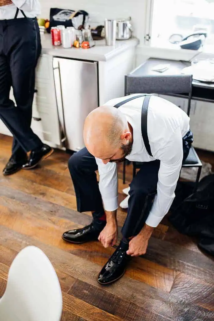 Handsome-Groomsmen-Tying-Classic-Sleek-Black-Shoe