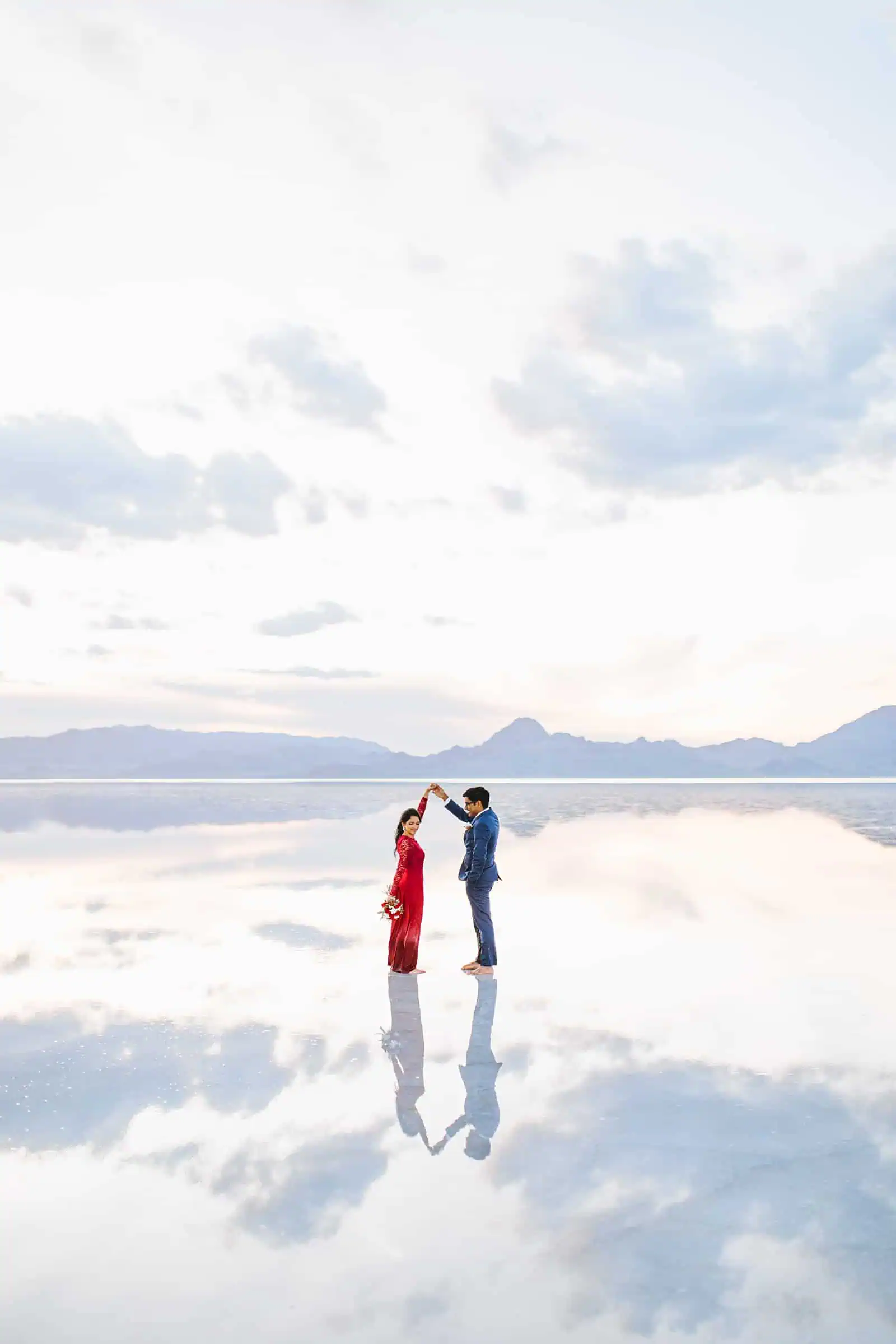 Bonneville Salt Flats Engagement Photos, Utah engagement session, engagement photography, red dress, clouds, water reflection, destination wedding