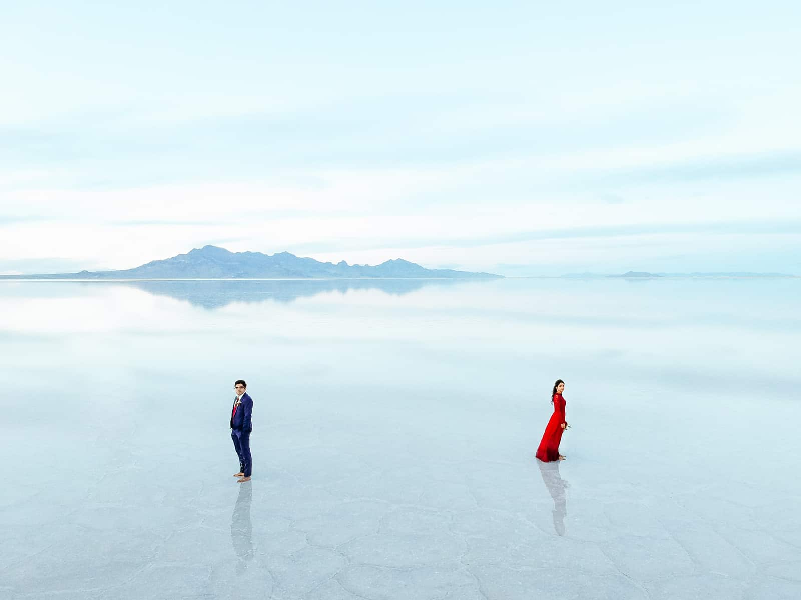 drone photography, Bonneville Salt Flats Engagement Photos, Utah engagement session, engagement photography, red dress, clouds, water reflection, destination wedding