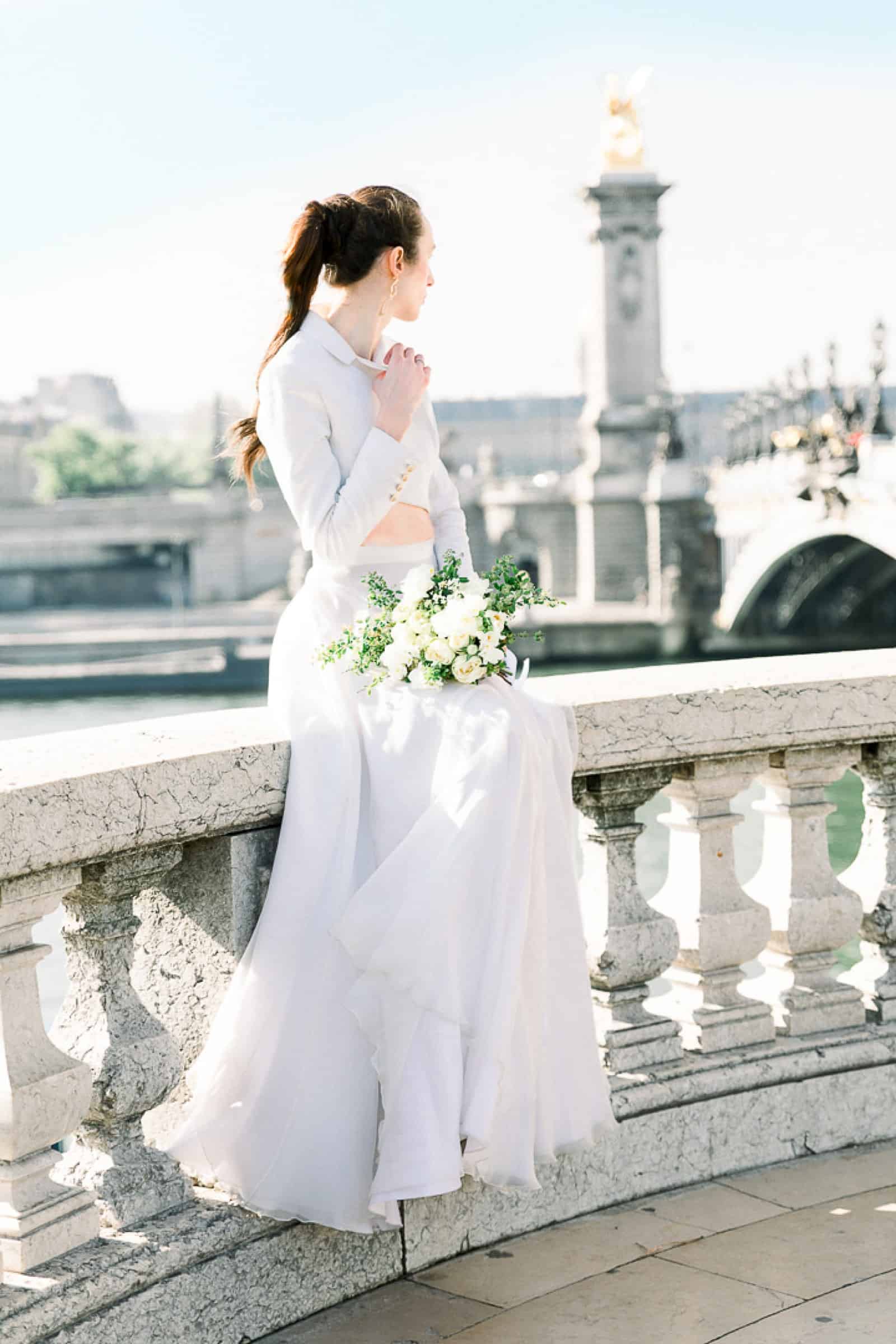 Modern high fashion bride in Paris, France at Pont Alexandre III bridge