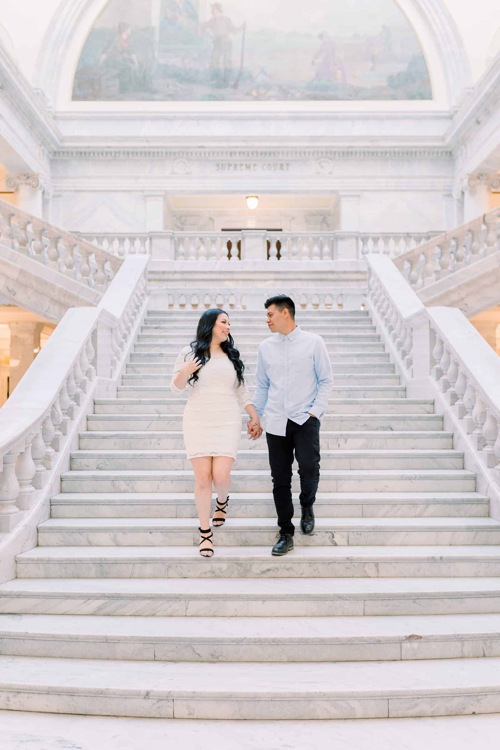 Classy engagement photos at the Utah State Capitol Building in downtown Salt Lake City, outfit for engagement pictures, short white lace dress and light blue button up shirt, big white staircase