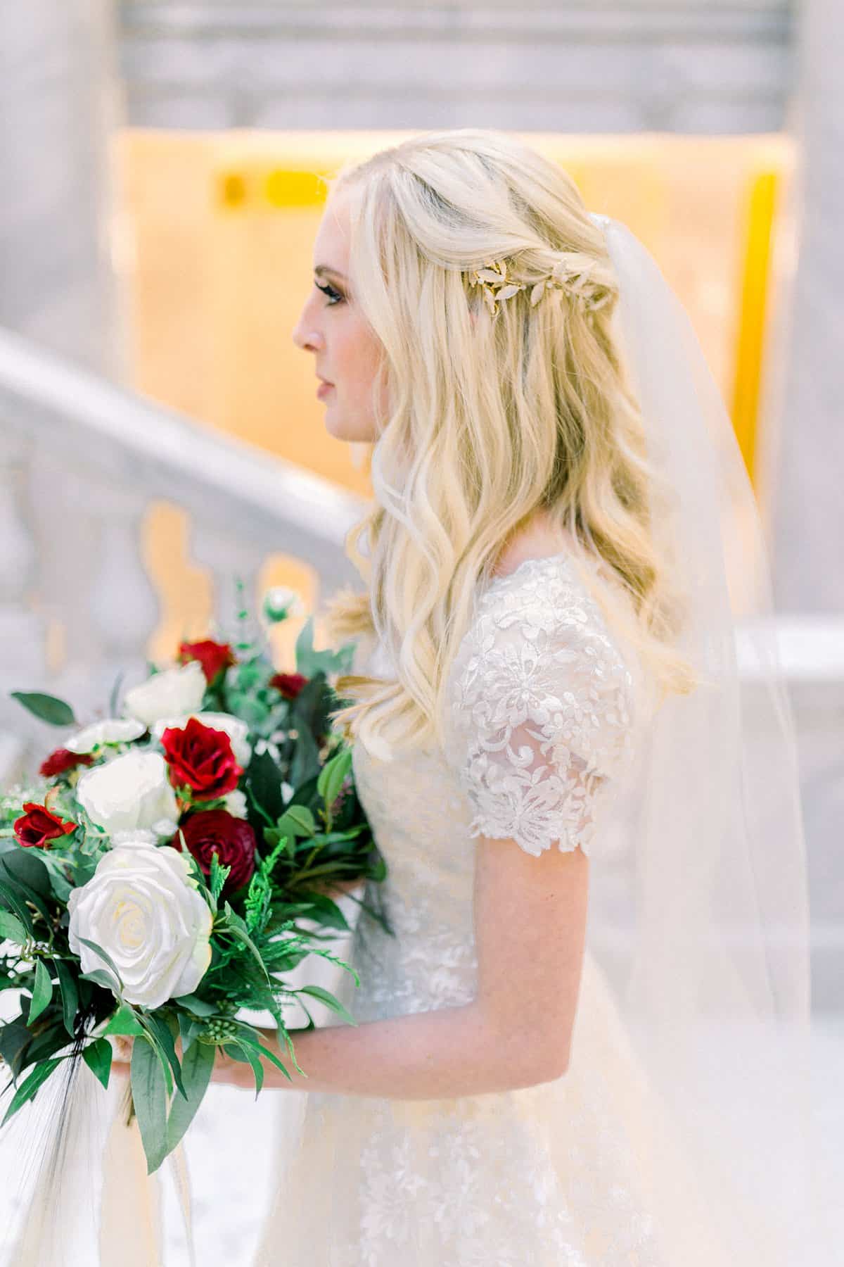 Modest lace wedding dress, bride long hairstyle, red and white wedding flowers bouquet