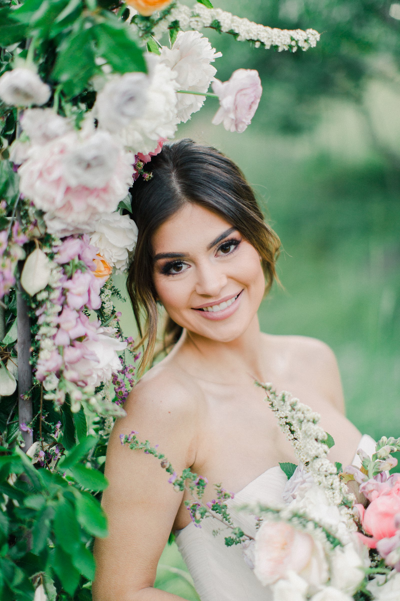Outdoor Spring Secret Garden Wedding, Provo Utah Film Wedding Photography, floral arch wedding flowers, bride wearing BHLDN wedding dress with sweetheart neckline