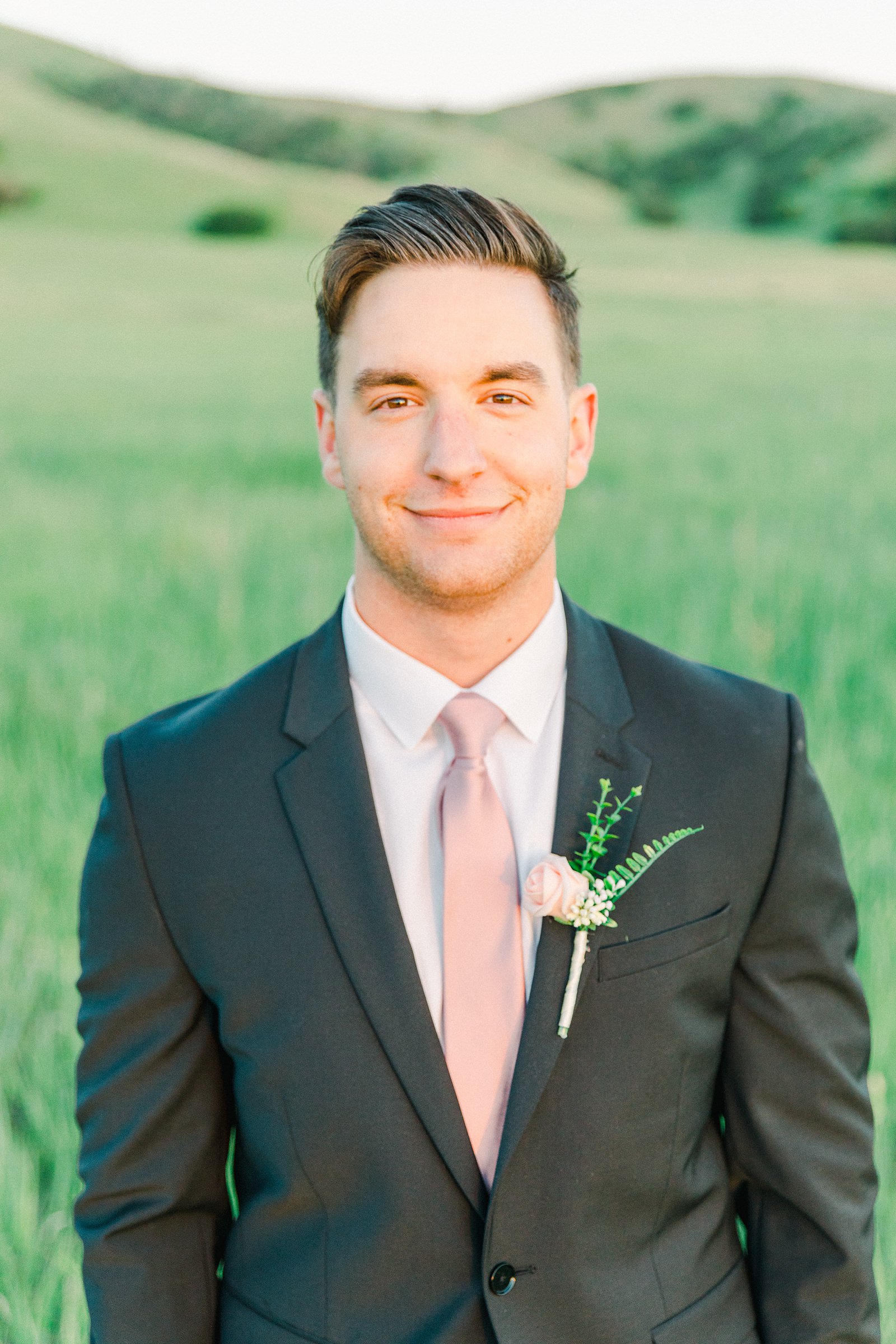 Salt Lake City Utah Bridal Wedding Photography, Tunnel Springs Park, groom in dark gray suit and pink tie, open green field