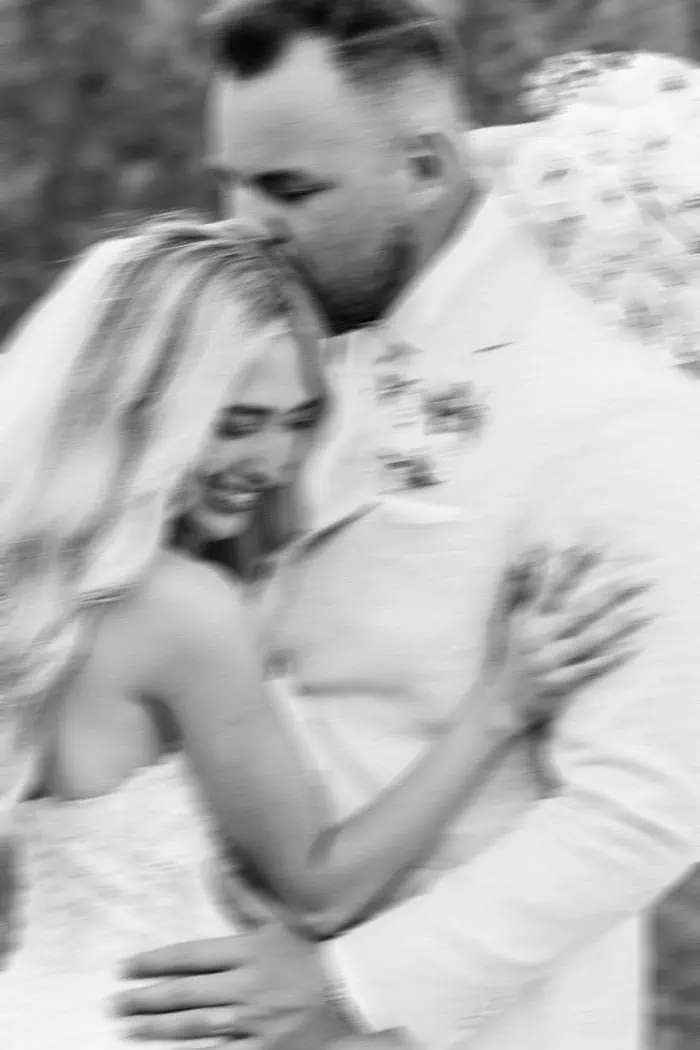 Wedding couple embracing in a natural setting.
