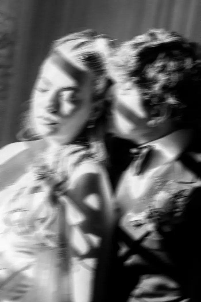 Elegant couple dancing at a wedding reception, captured in black and white.