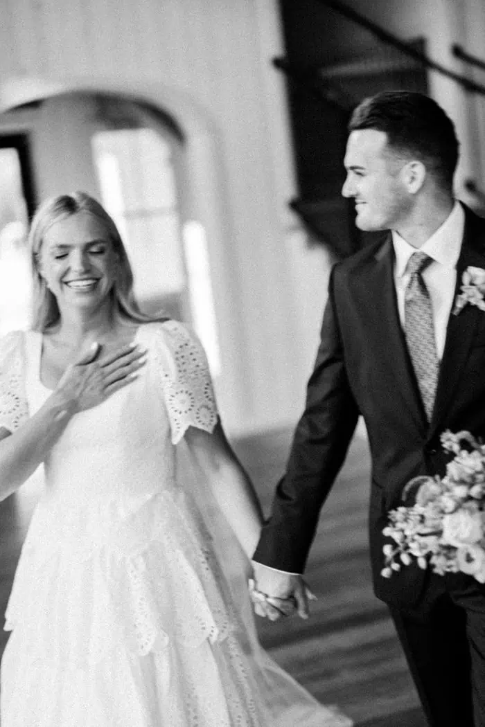 Wedding couple holding hands during ceremony.