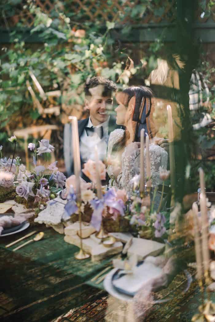 Romantic wedding scene featuring a smiling couple at a beautifully decorated table.