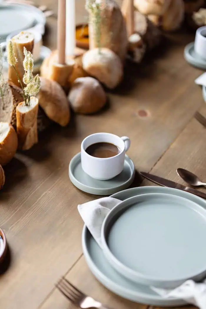Coffee cup on a saucer with a wooden table background.