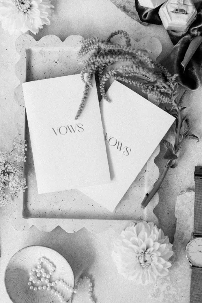 Elegant flat lay of wedding accessories and flowers in black and white.