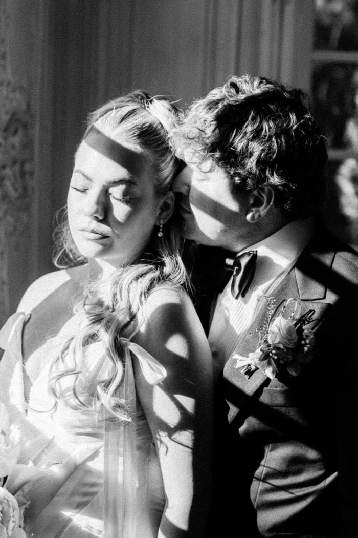 Romantic wedding couple portrait with dramatic lighting and shadows.