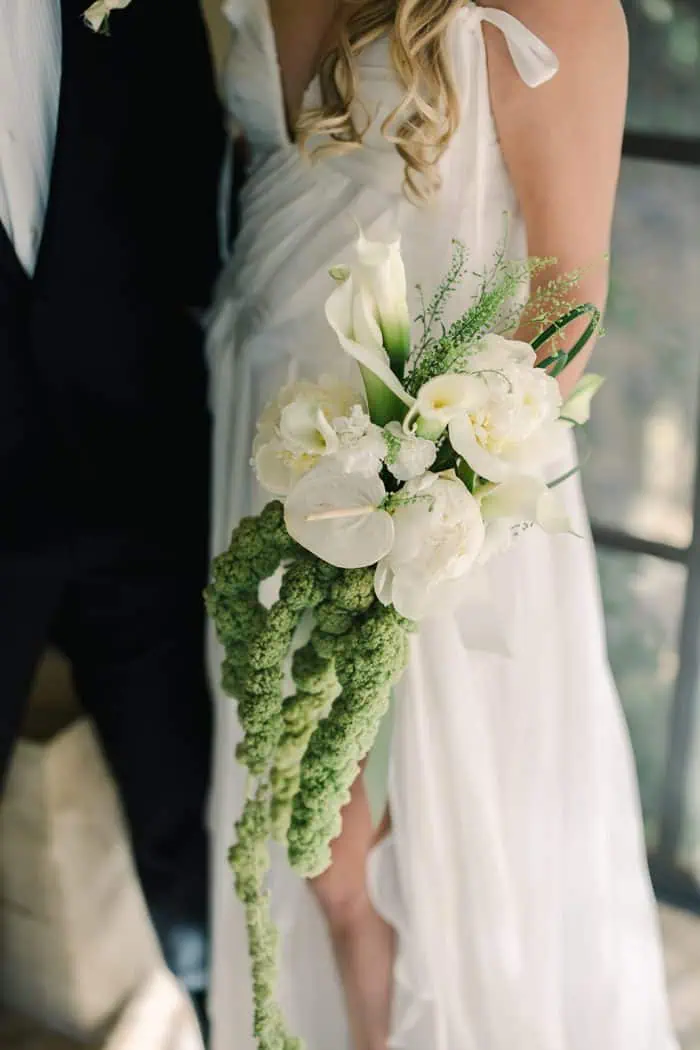Elegant wedding bouquet featuring white calla lilies and lush greenery for a romantic ceremony.