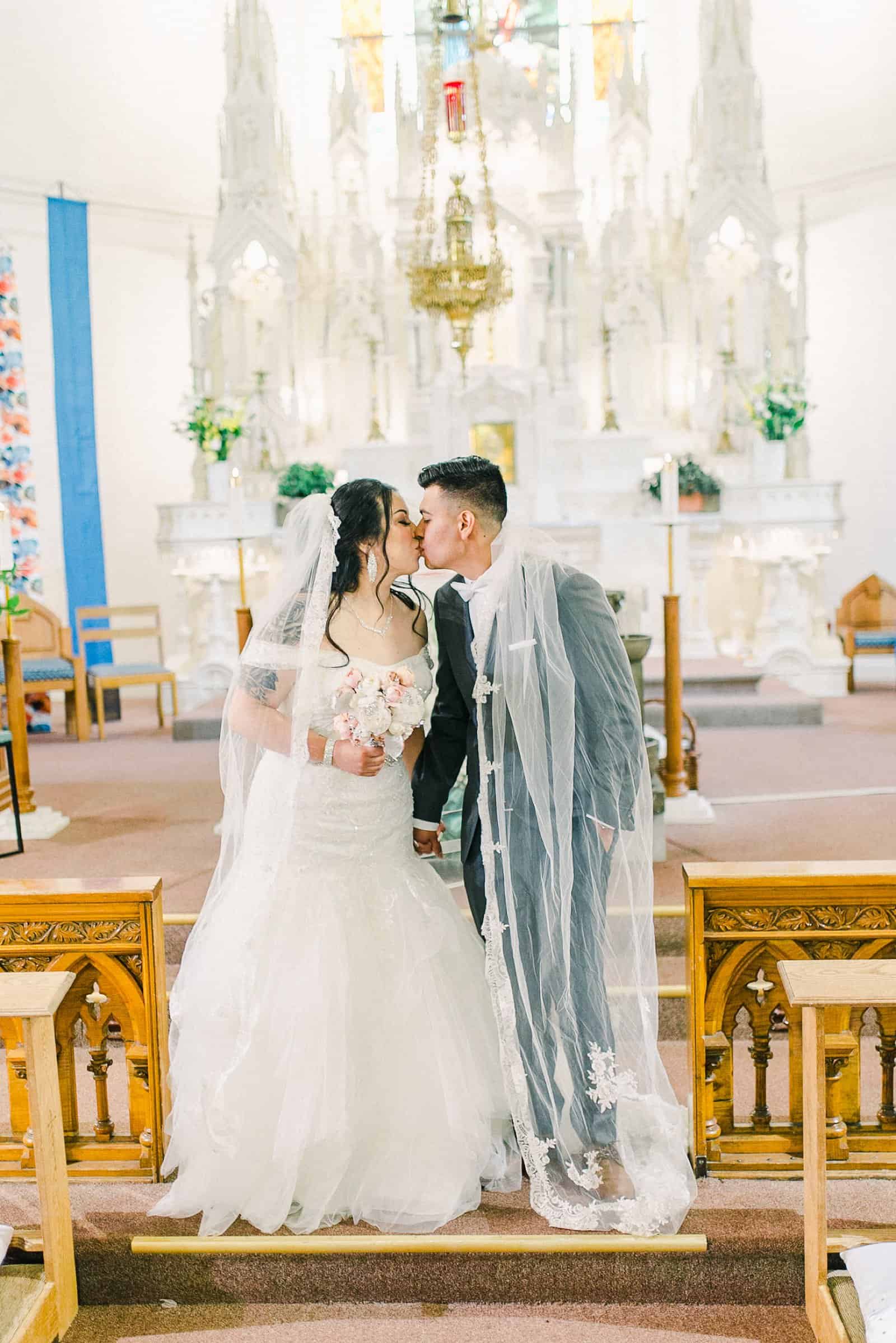 Cache Valley Logan Traditional Catholic Wedding Ceremony in a cathedral, Utah wedding photography, first kiss