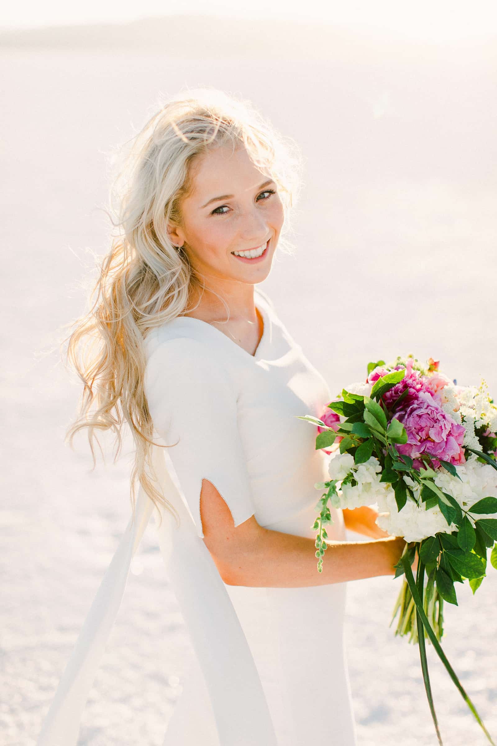 Bonneville Salt Flats Utah Wedding Photography, destination wedding, bride in modern simple white wedding dress, boho bride, pink and white wedding bouquet