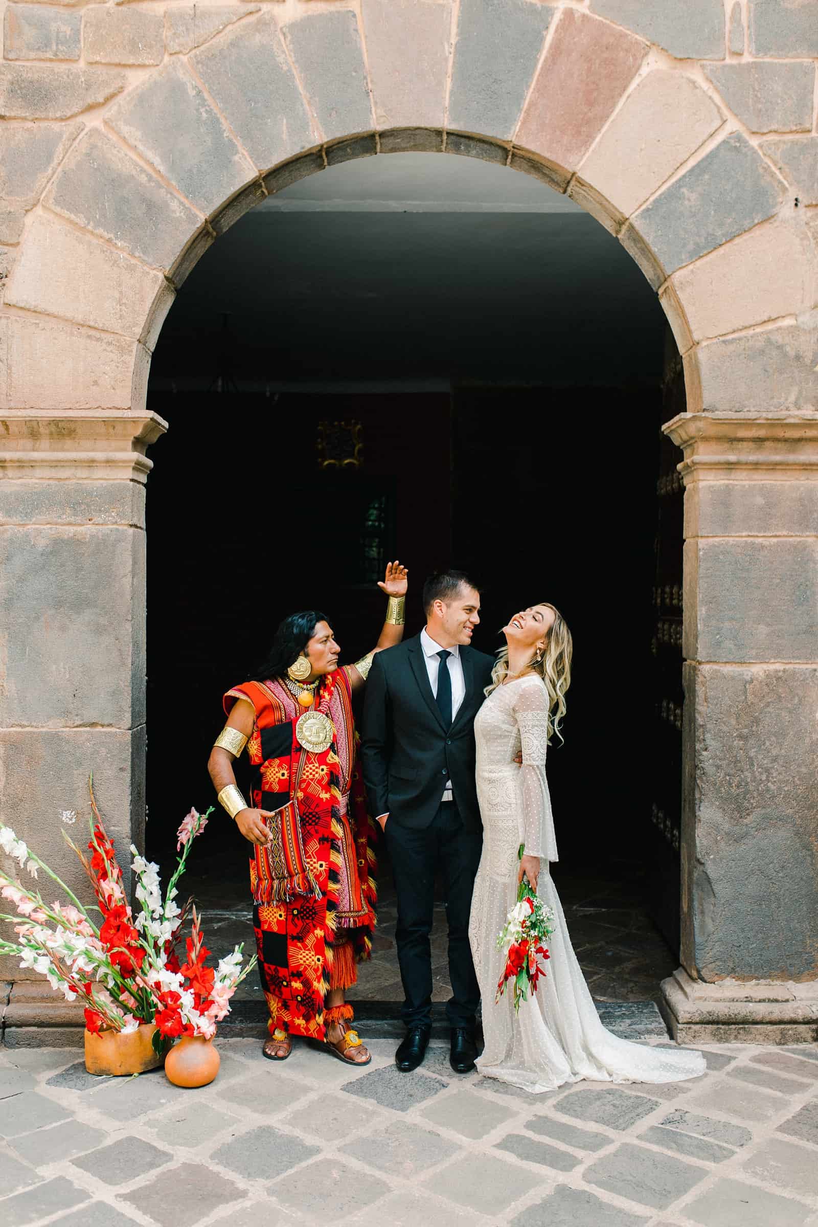Cusco Peru Destination Wedding, travel wedding photography, Plaza de Armas ceremony with shaman, red flowers boho wedding