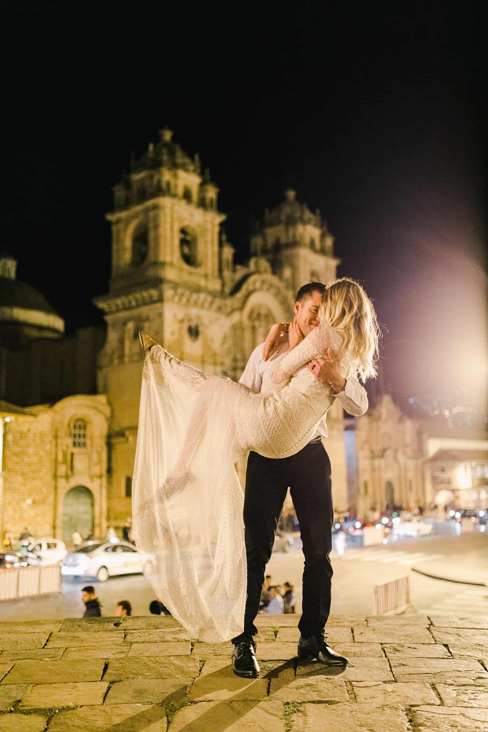 Cusco Peru Destination Wedding Inspiration, travel photography, bride and groom dance in front of Cusco Cathedral at Plaza de Armas at night