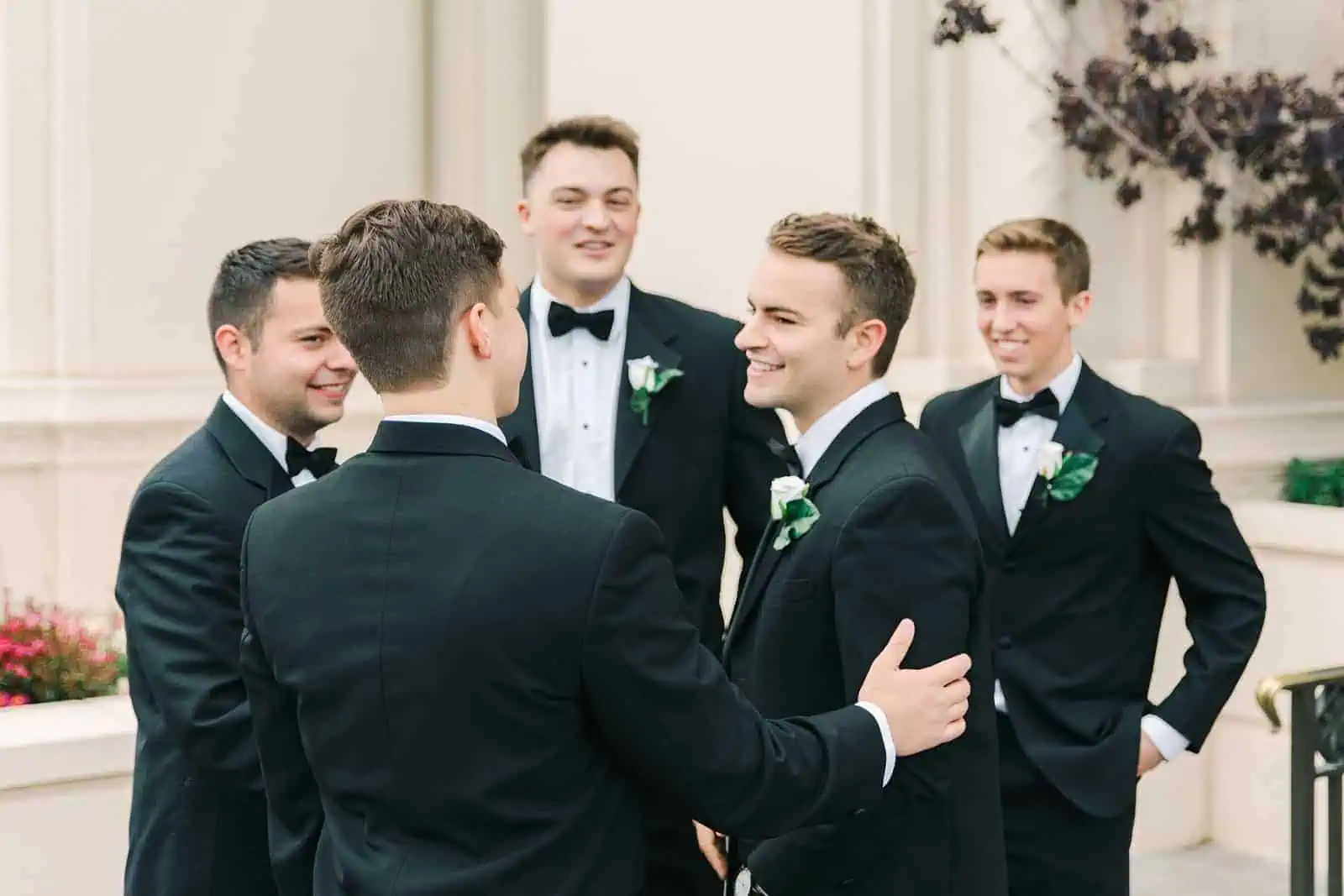 Payson Utah Temple wedding, groom with groomsmen wearing classic black tuxes with black bow ties