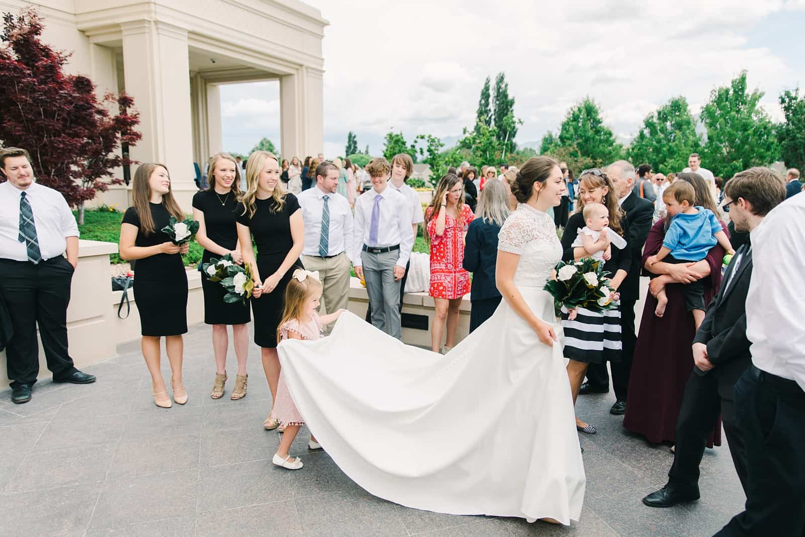 Payson Utah Temple wedding, flower girl holds bride's train