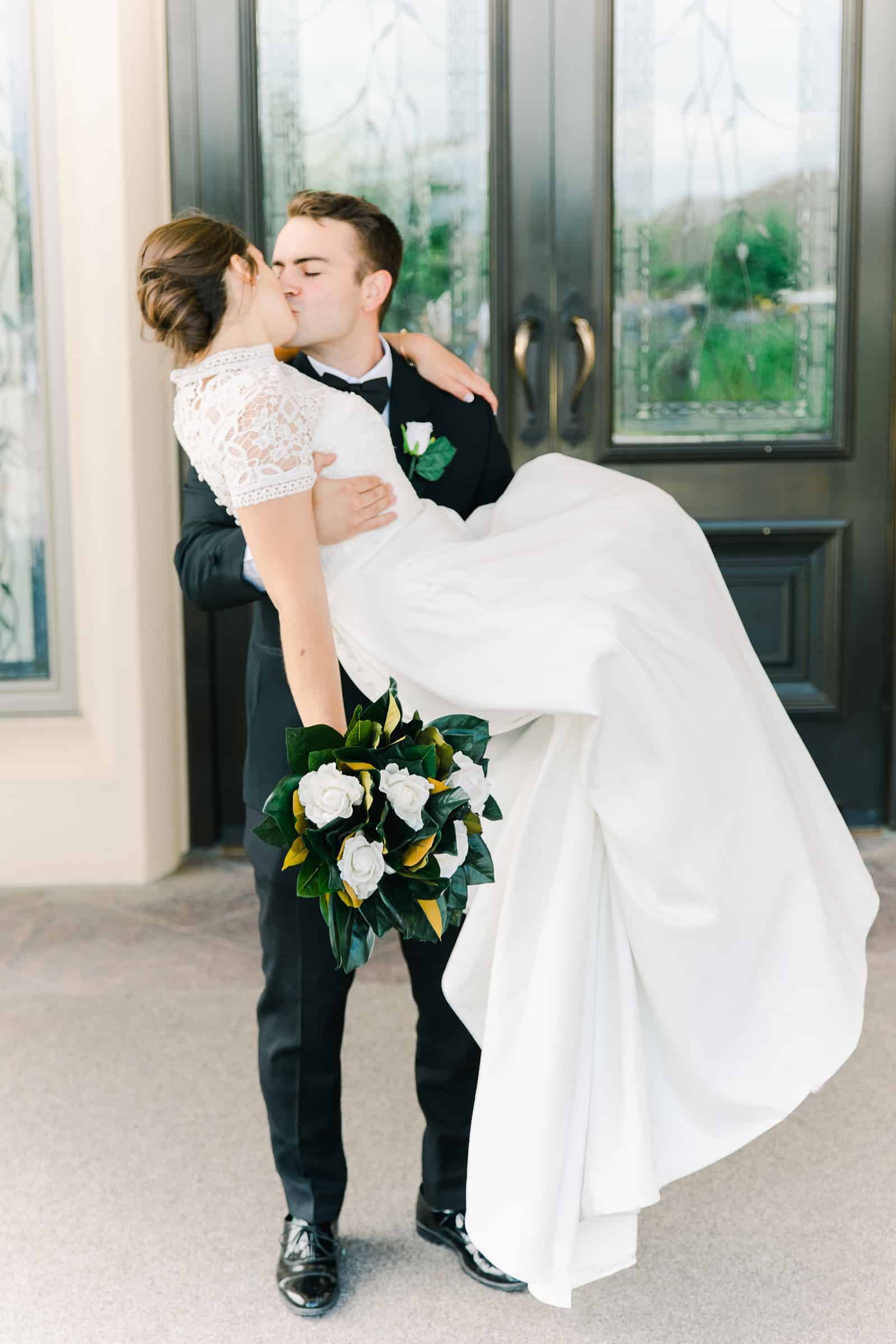 Payson Utah Temple wedding, groom carries bride