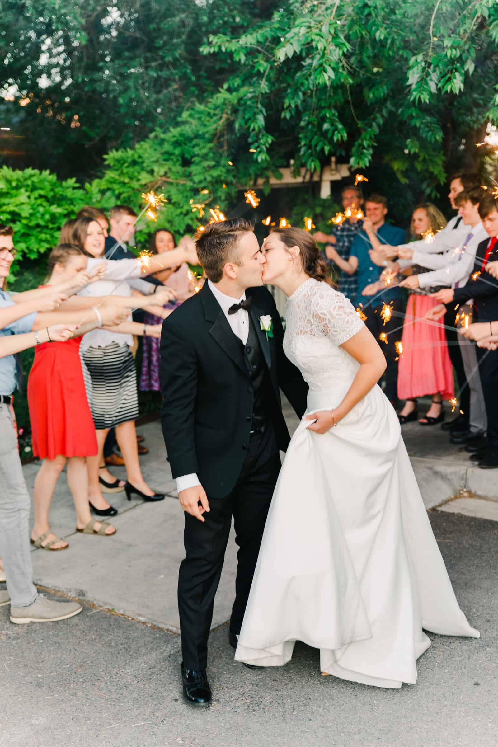 Clarion Gardens Payson Utah Wedding, bride and groom sparkler send off kiss