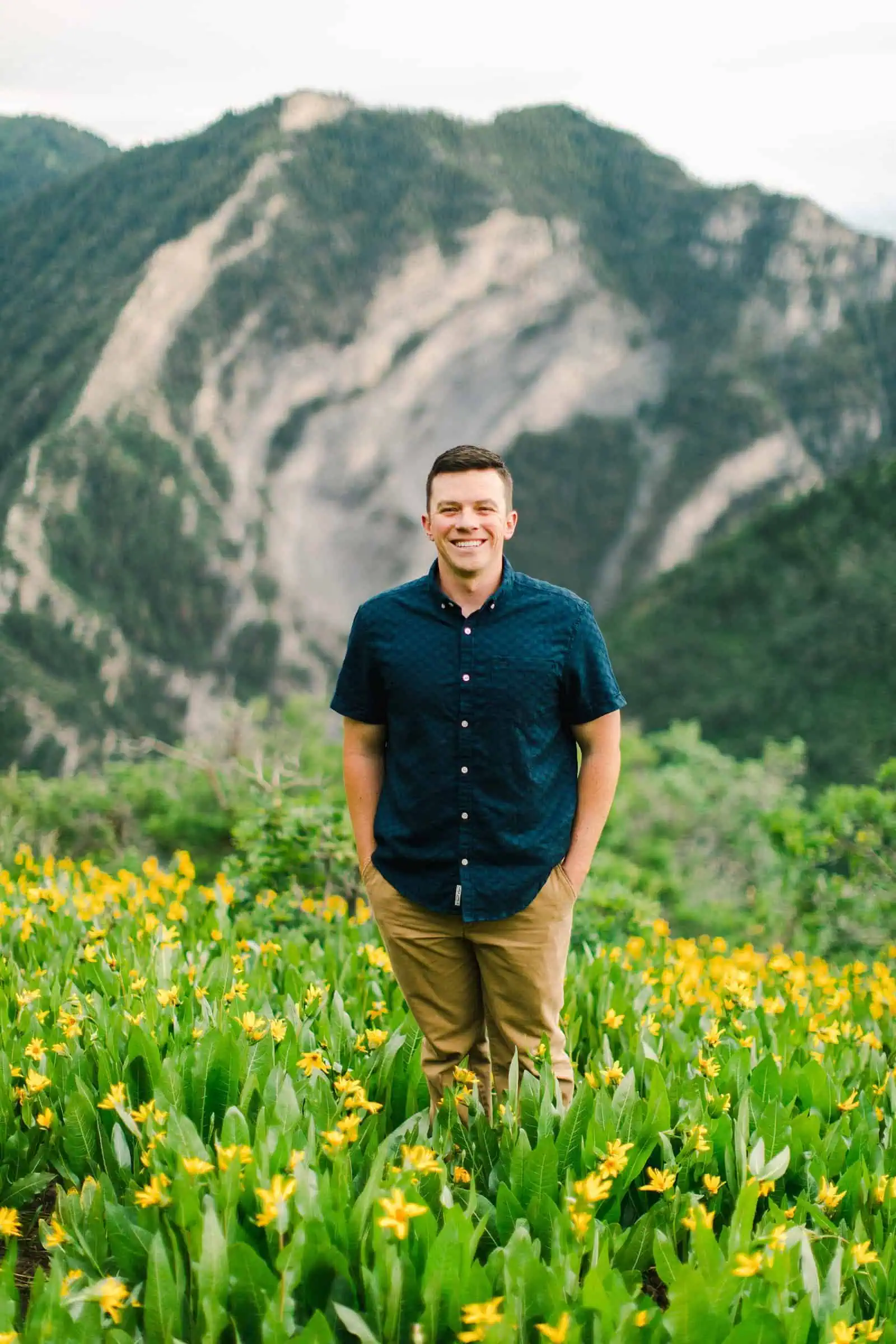 Provo Canyon wildflowers field engagement session, Utah wedding photography, groom in dark blue button up shirt and khaki pants