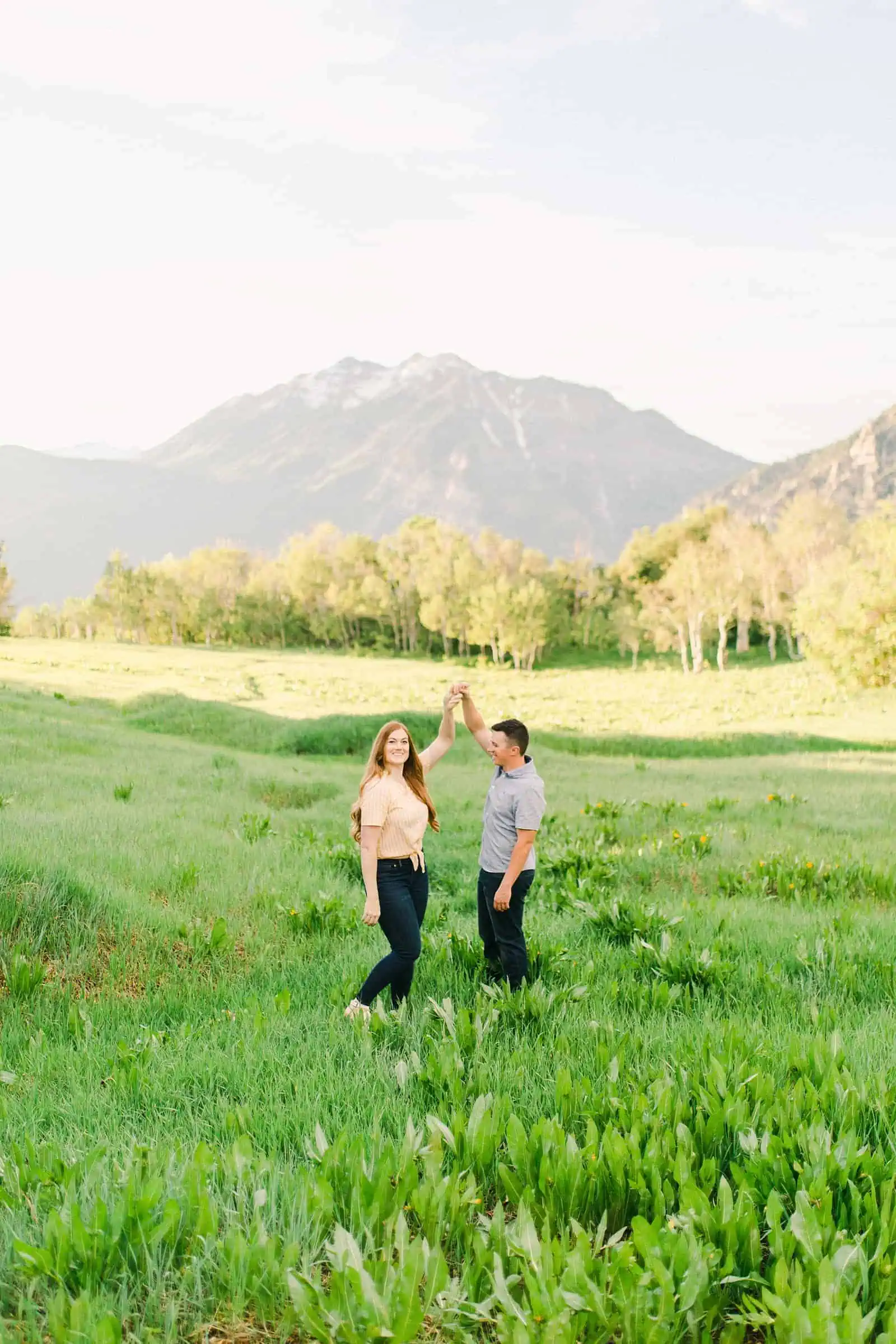 Provo Canyon wildflowers field engagement session, Utah wedding photography, engaged couple dancing in yellow flowers and mountains