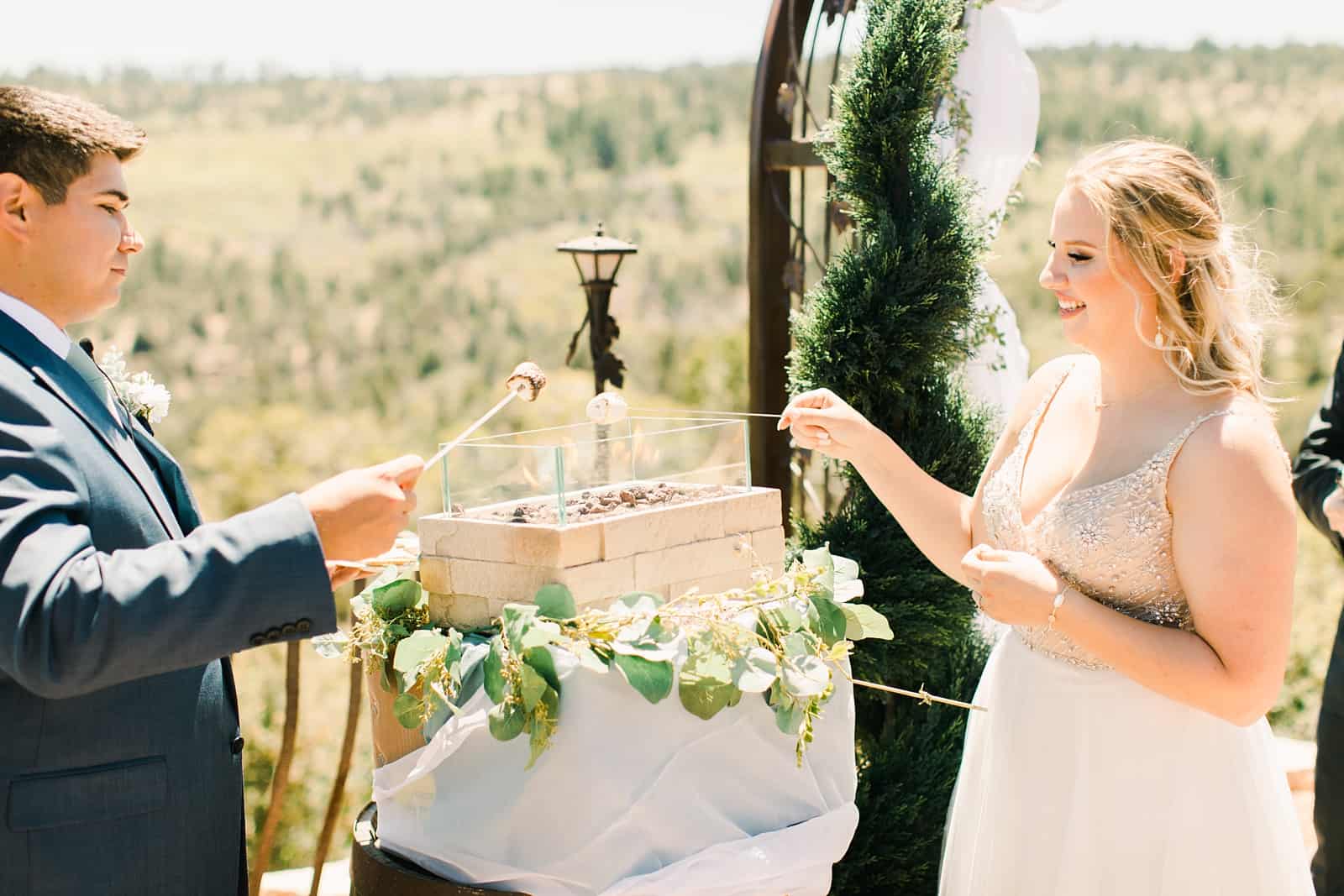 bride and groom roast s'mores during wedding ceremony