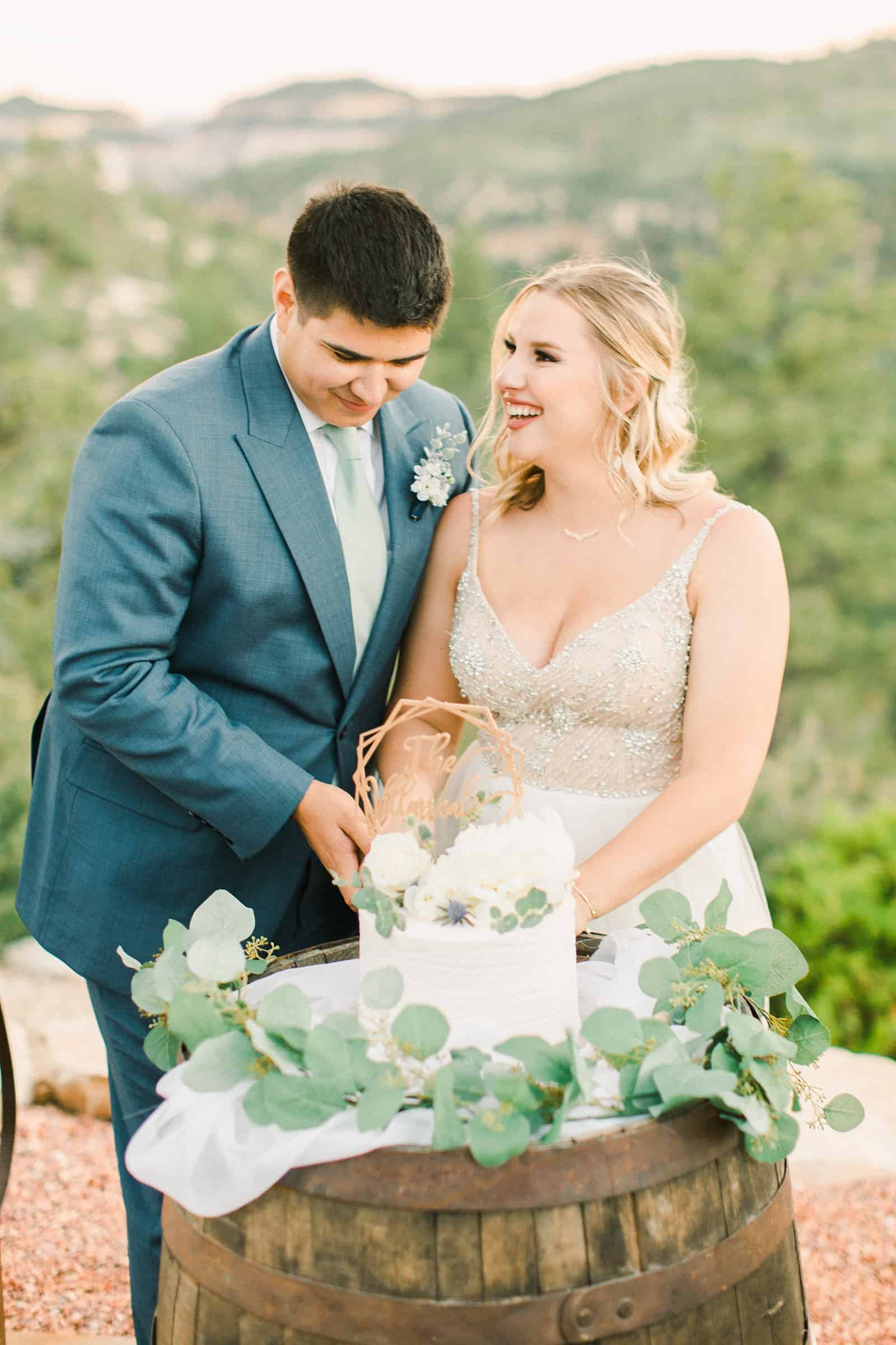 bride and groom cutting wedding cake