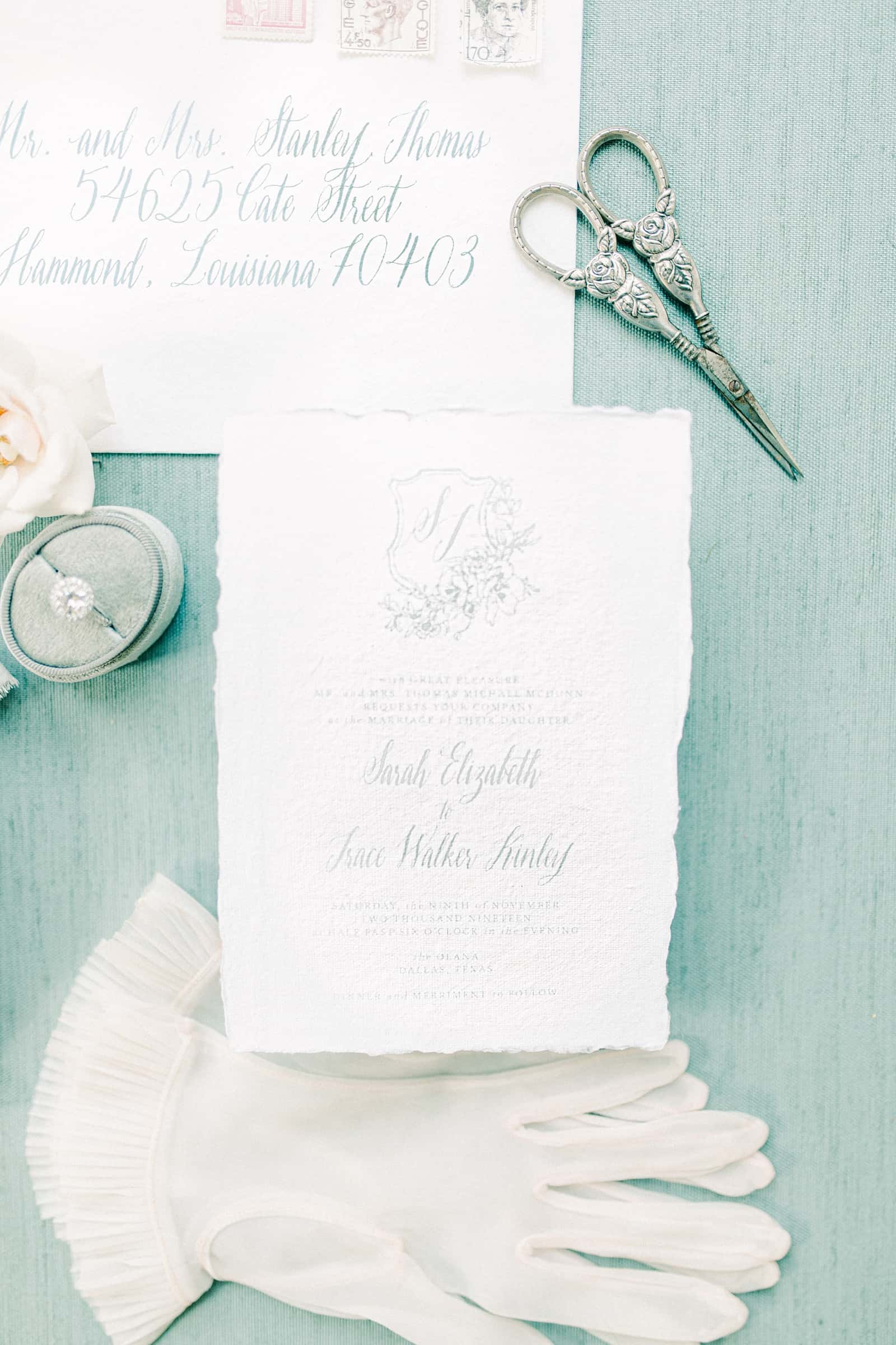 Fine art sketched European style wedding invitations on light blue background