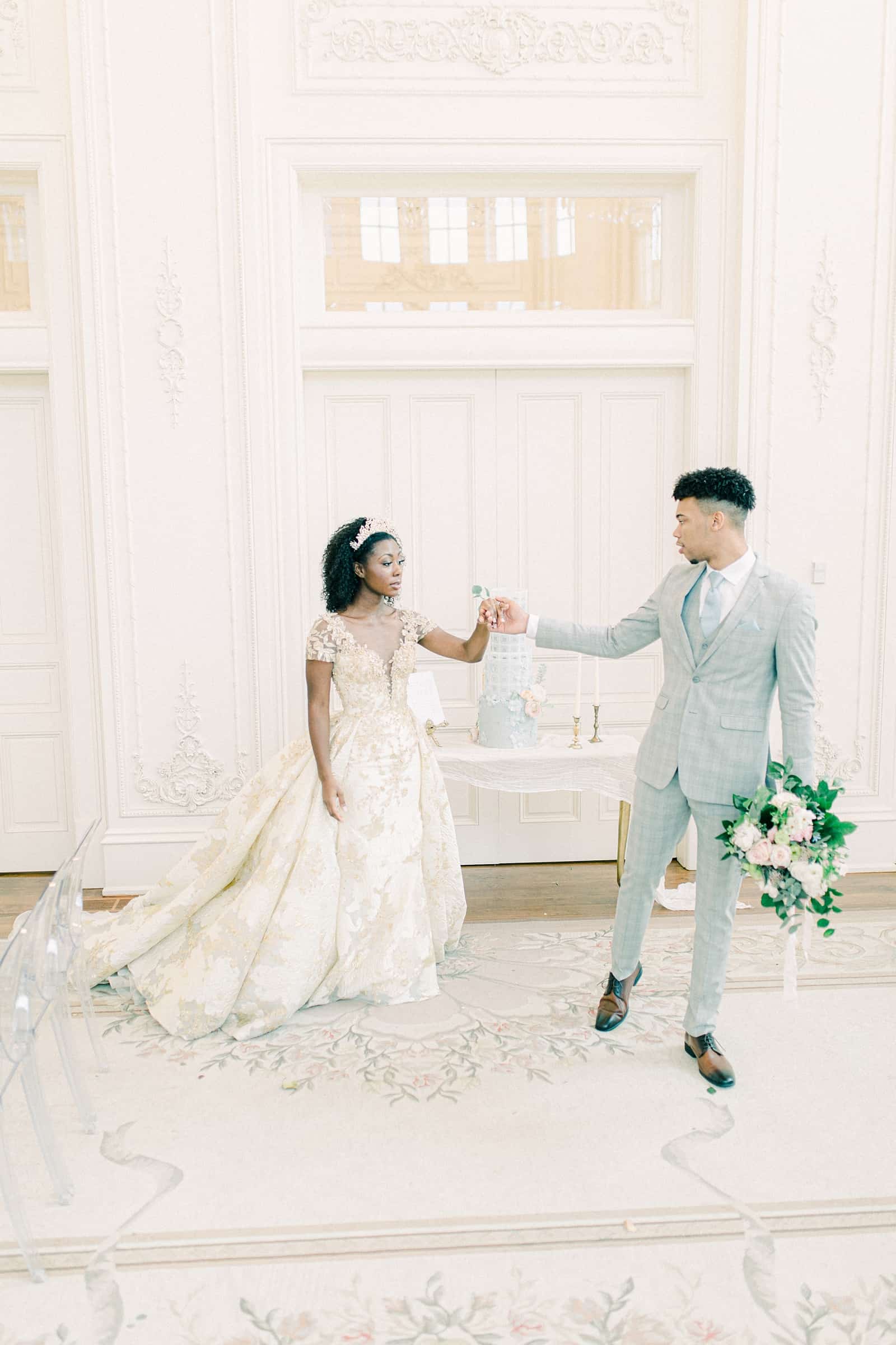 Fairytale bride and groom in all white ballroom, elegant wedding