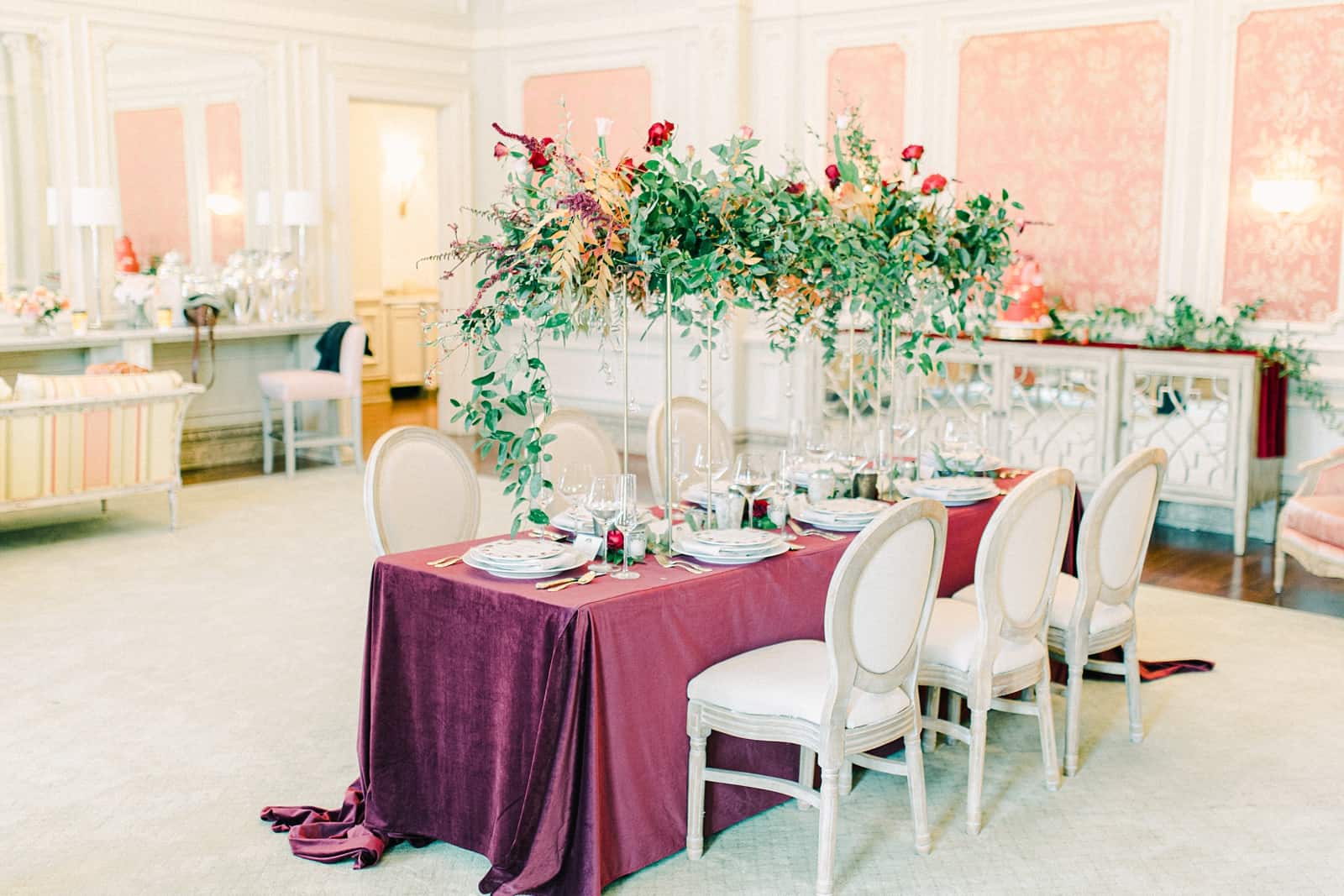 Maroon tablecloth, wedding table with tall geometric centerpieces