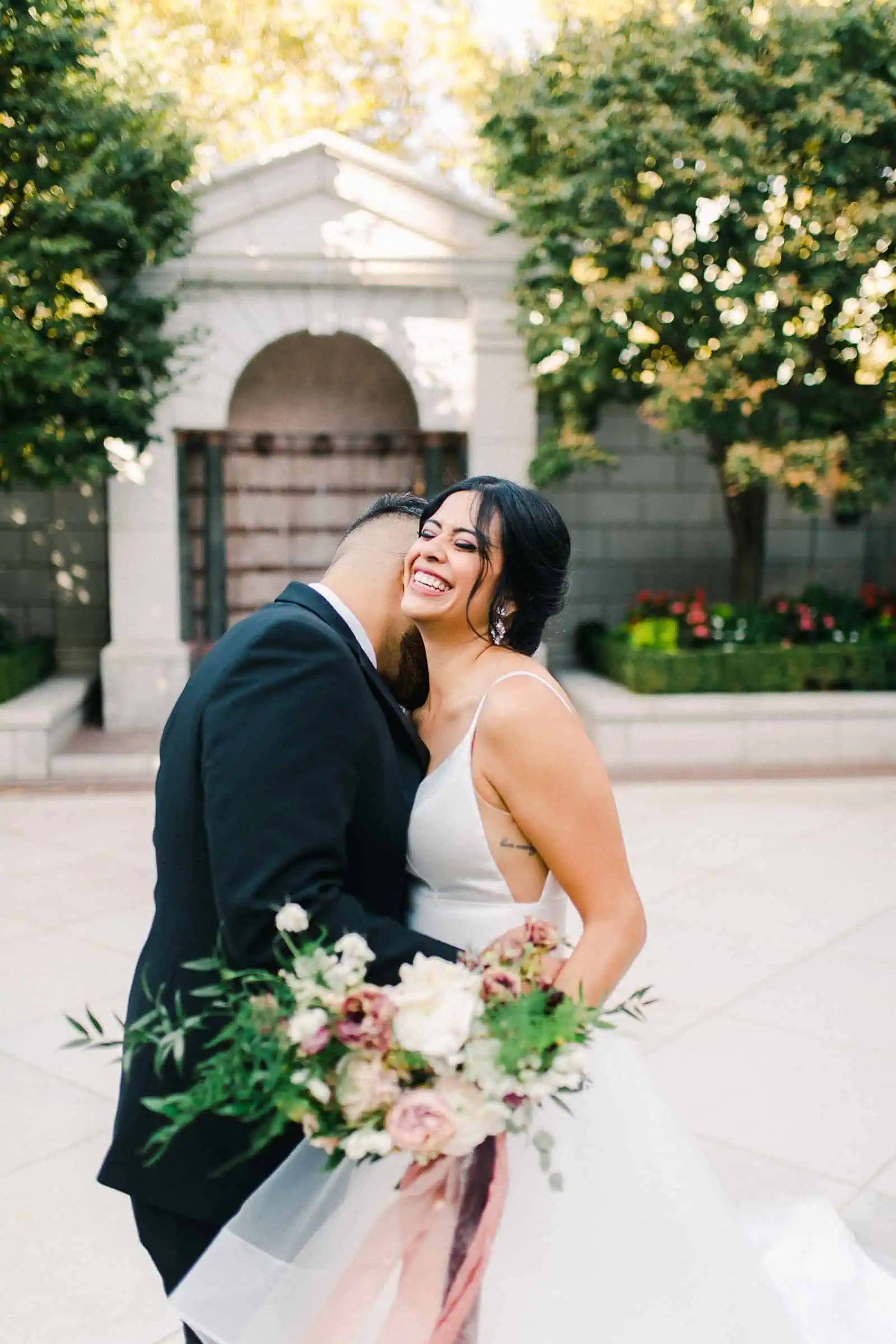 Bride and groom laughing together on their wedding day