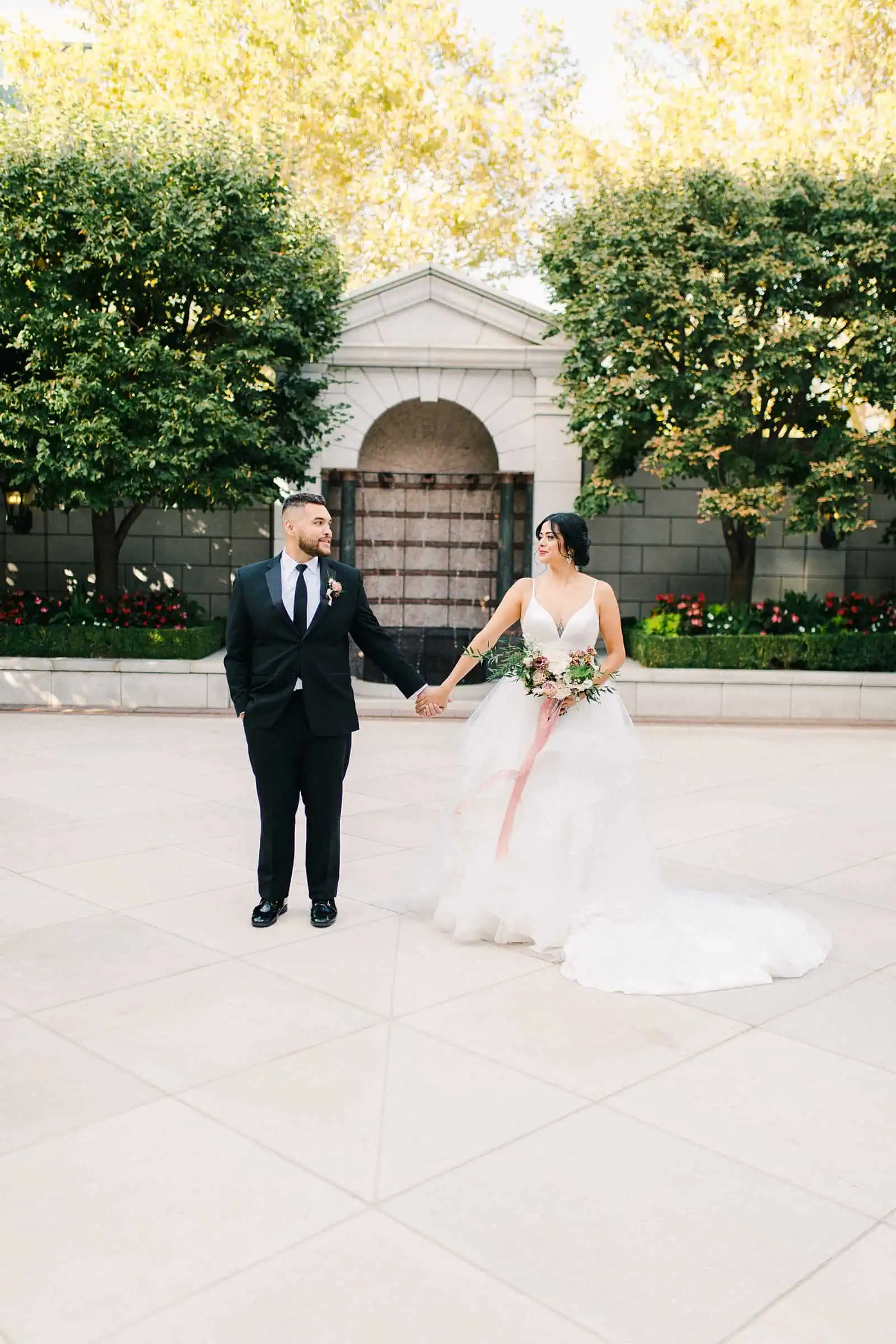 Bride and groom hold hands on their wedding day