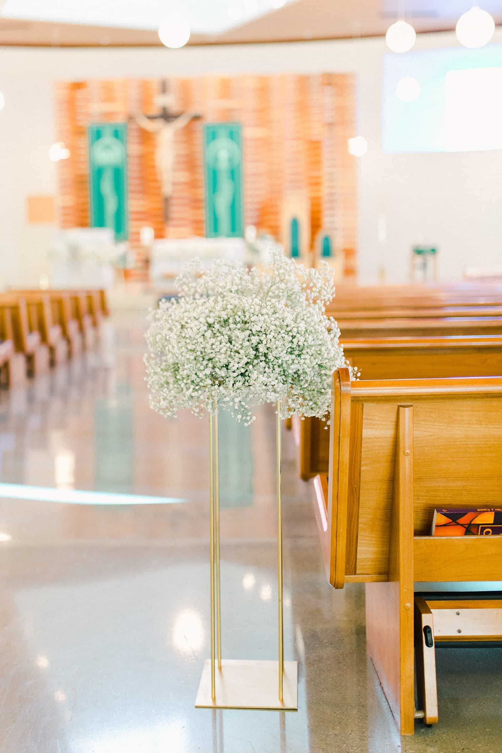 Baby's breath arrangement during cathedral wedding ceremony