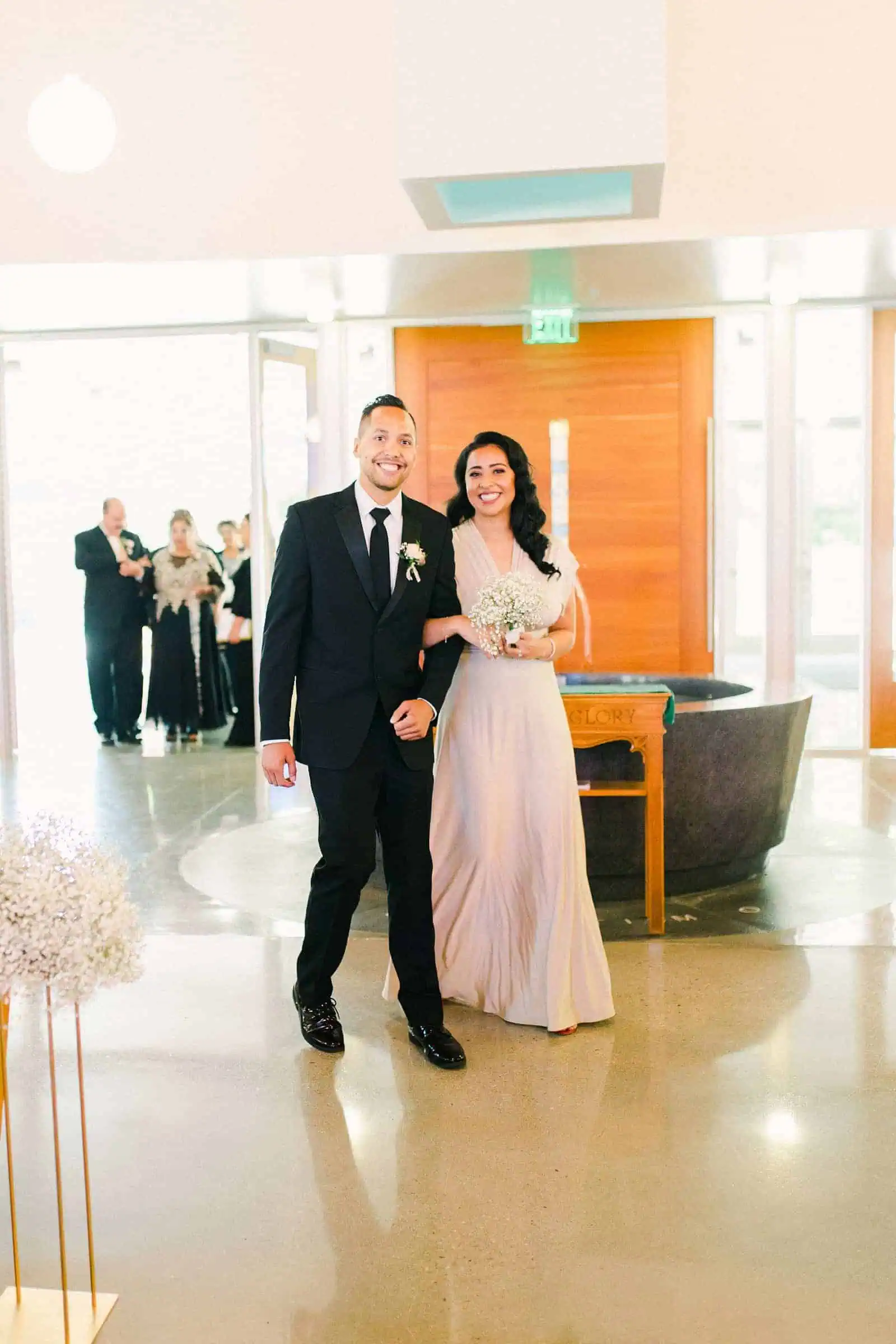 Groomsman and bridesmaid walk down the aisle