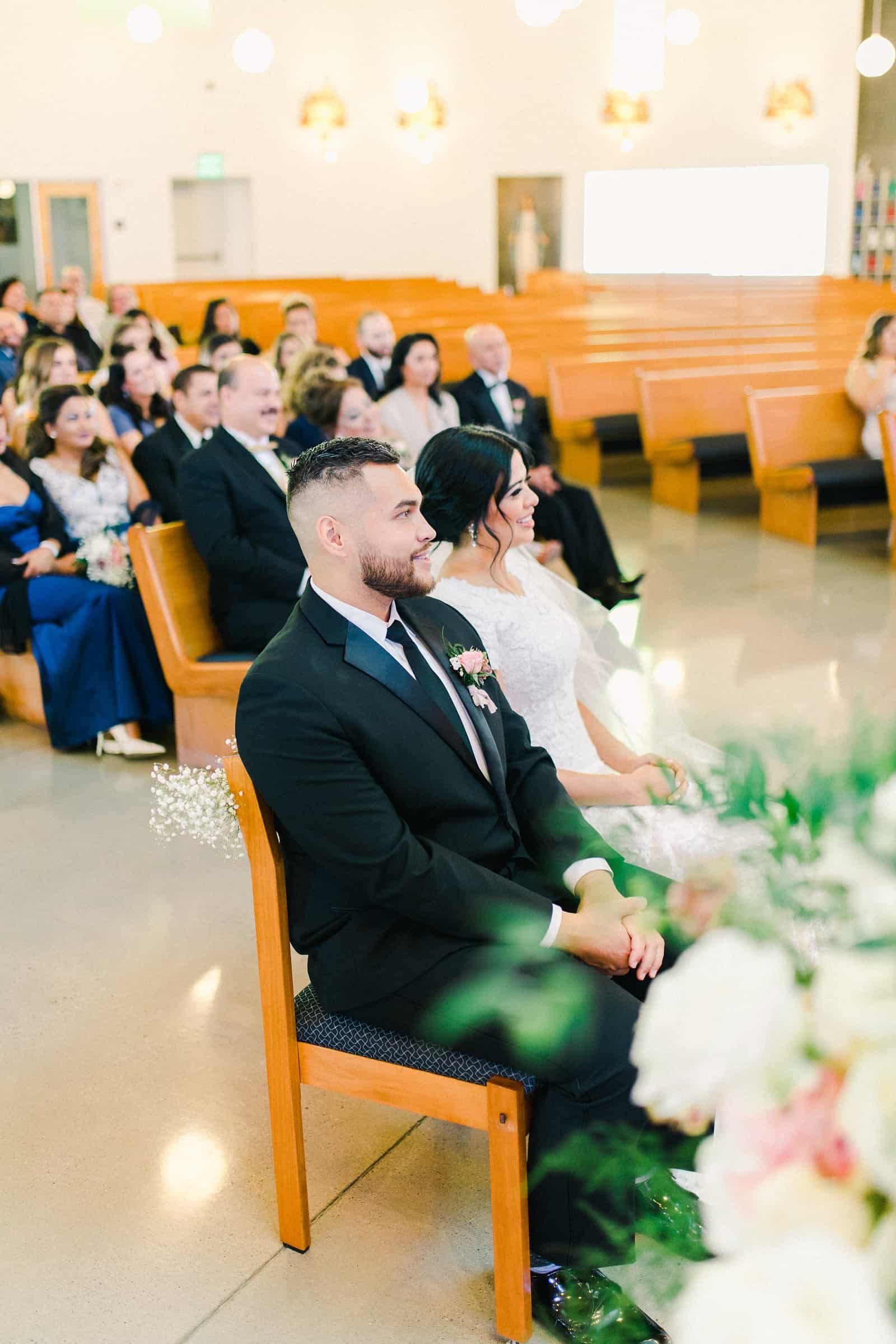 Chapel cathedral ceremony in Utah, bride and groom sitting