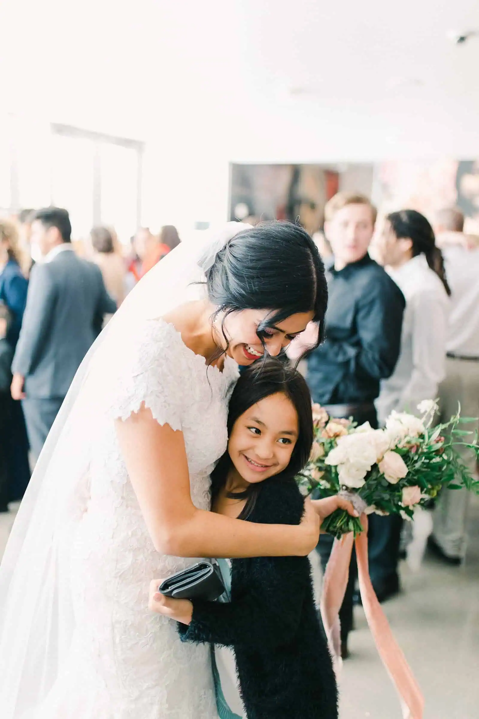 Bride hugs guest after wedding ceremony