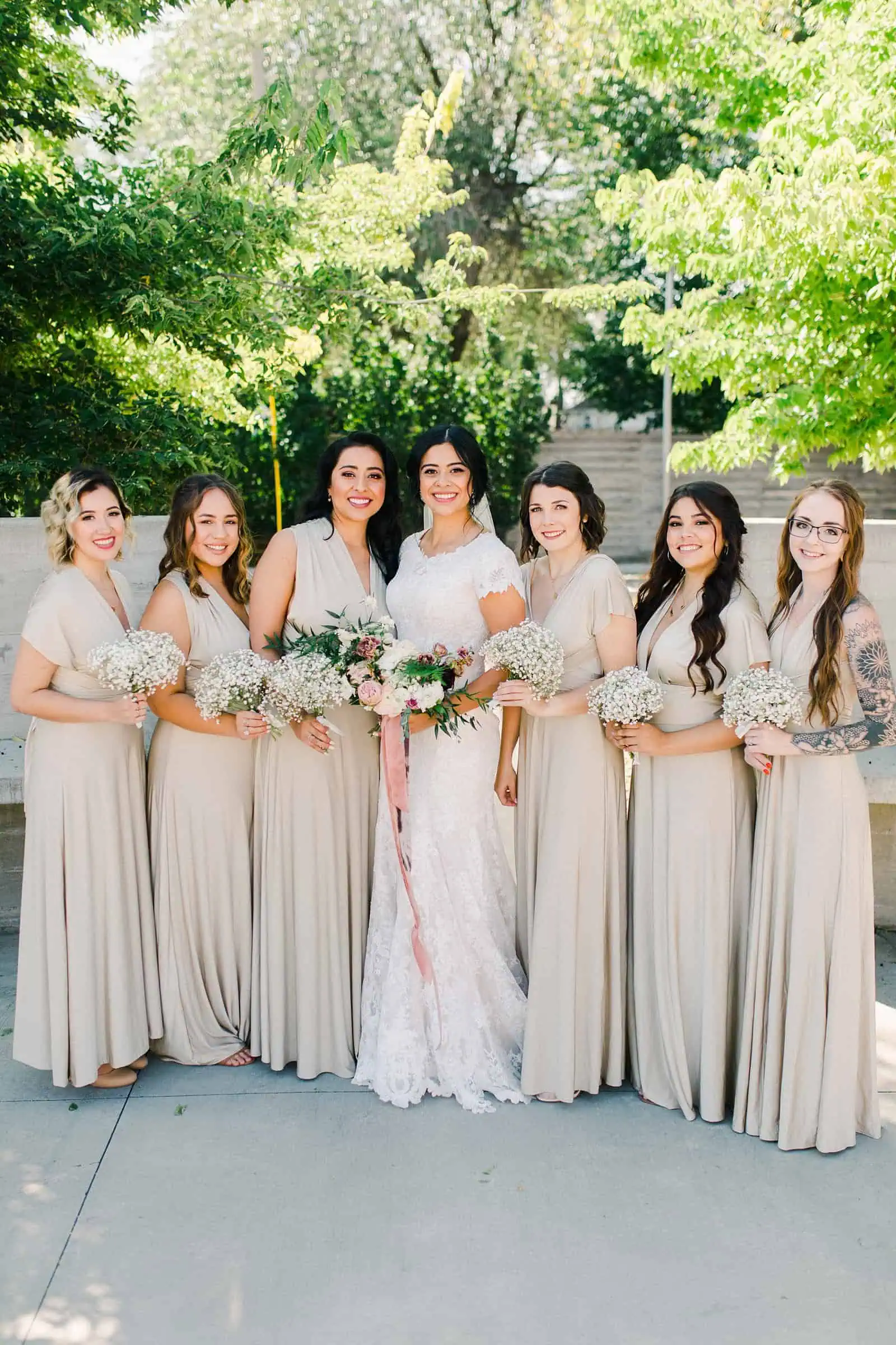 bride and bridesmaids wearing gold champagne long maxi bridesmaids dresses with bouquets