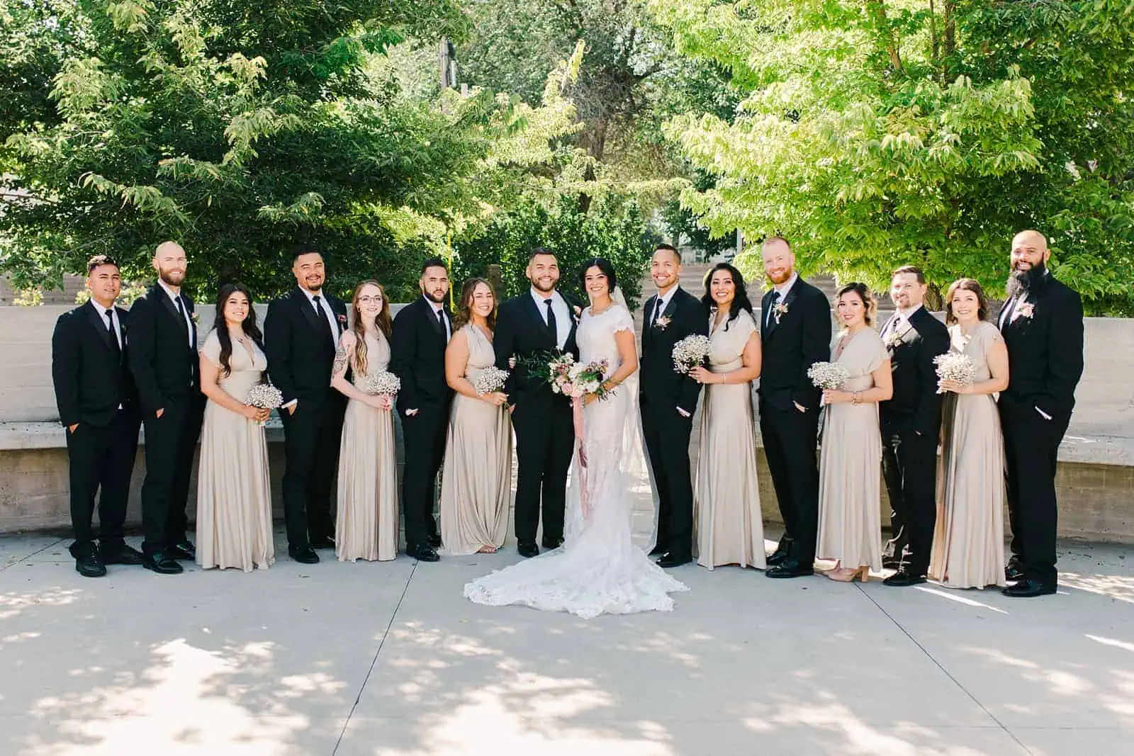 bride and bridesmaids wearing gold champagne long maxi bridesmaids dresses with bouquets