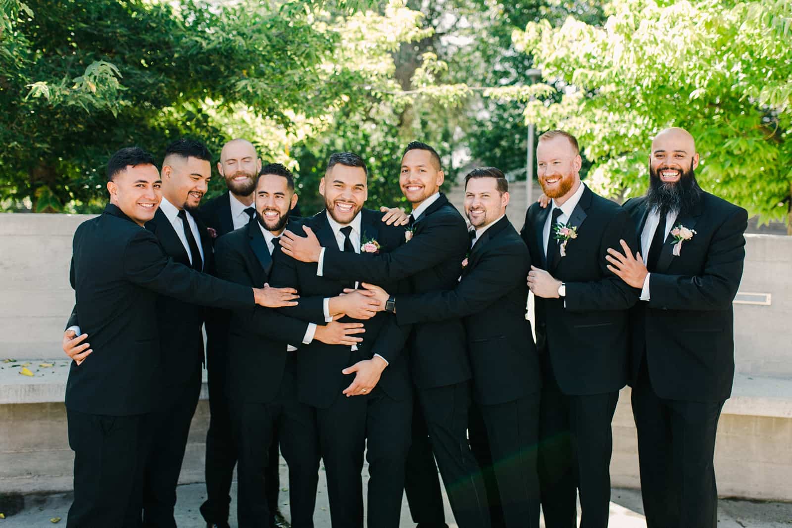 Groom and groomsmen in classic black tuxedos