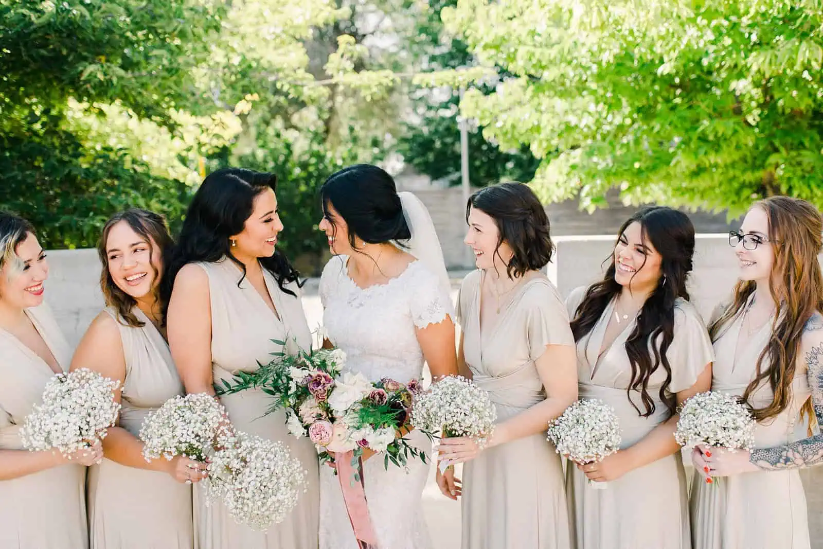 bride and bridesmaids wearing gold champagne long maxi bridesmaids dresses with baby's breath bouquets