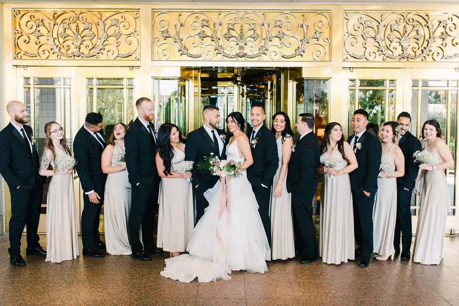 Bridal party with bride and groom outside the Grand America Hotel