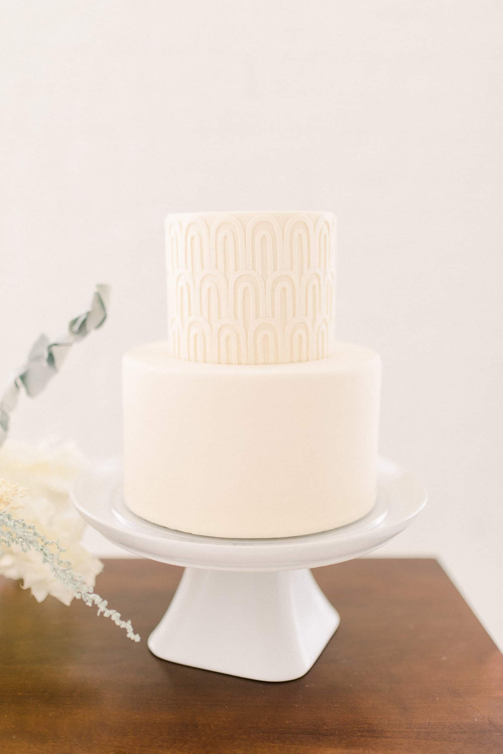 Modern minimalist white wedding cake with geometric design