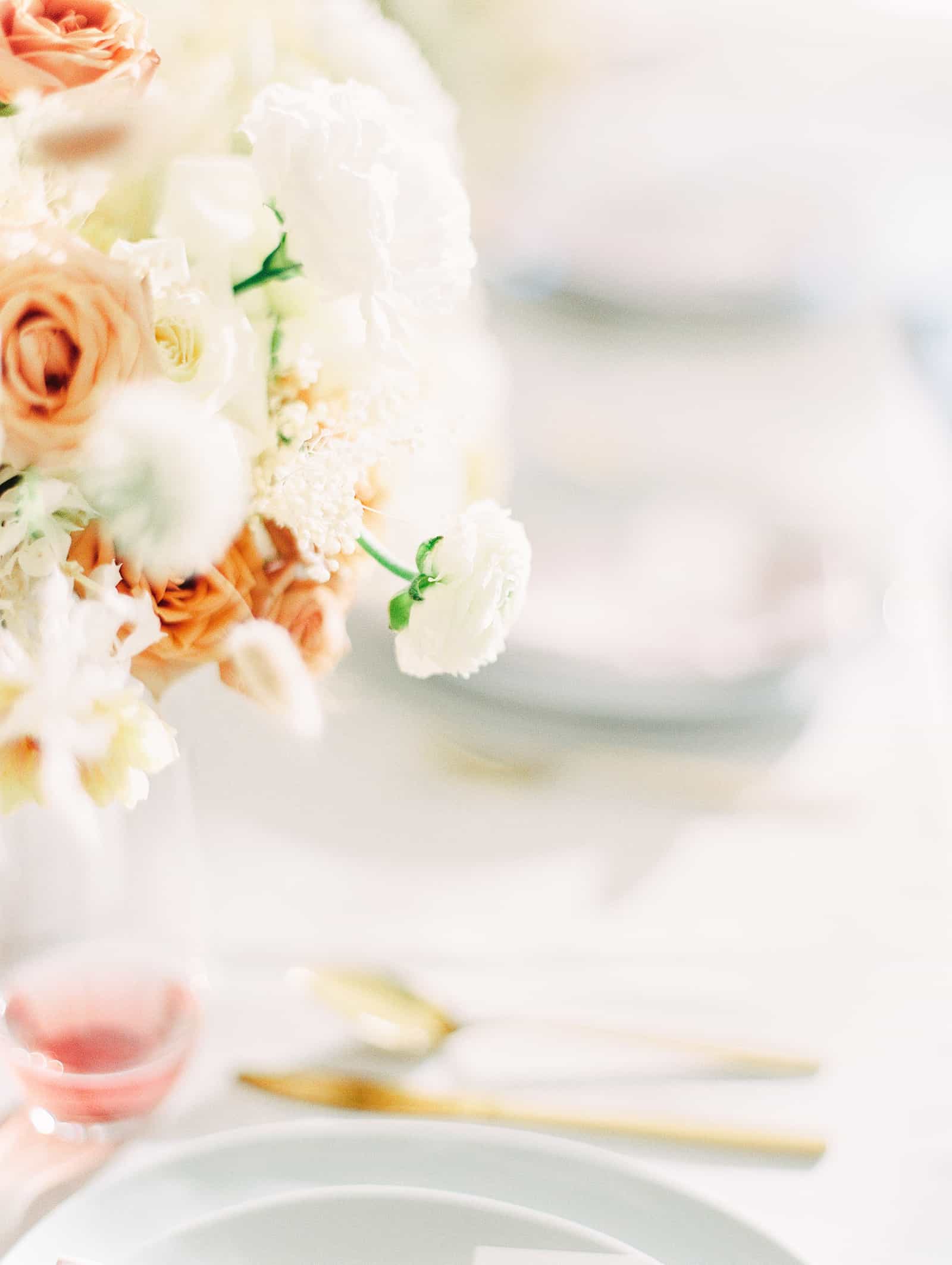 Modern wedding table with white and orange flower centerpiece