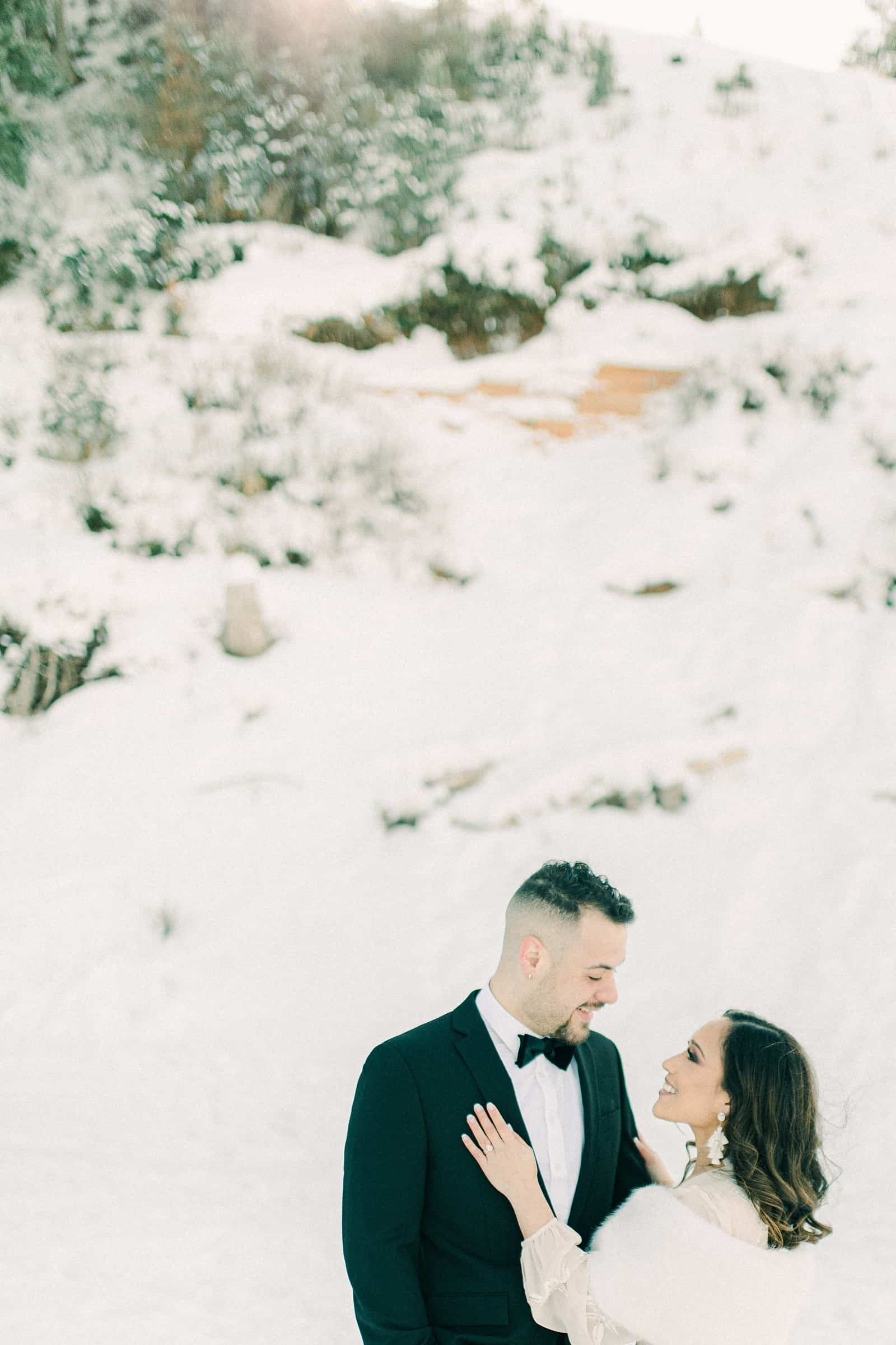 Bride and groom snowy winter mountains of Utah