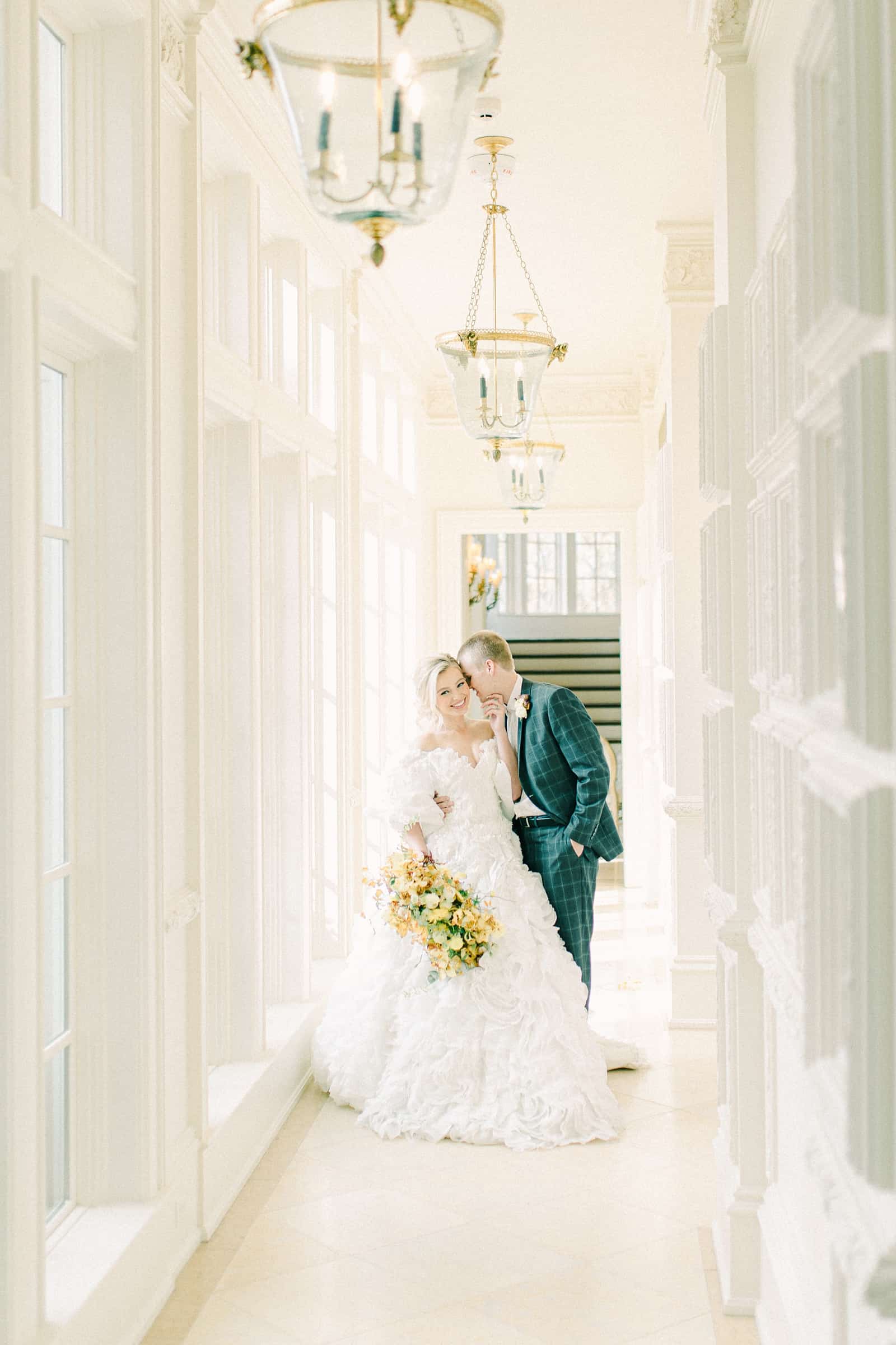 Bride and groom in white hallway , bride and groom poses