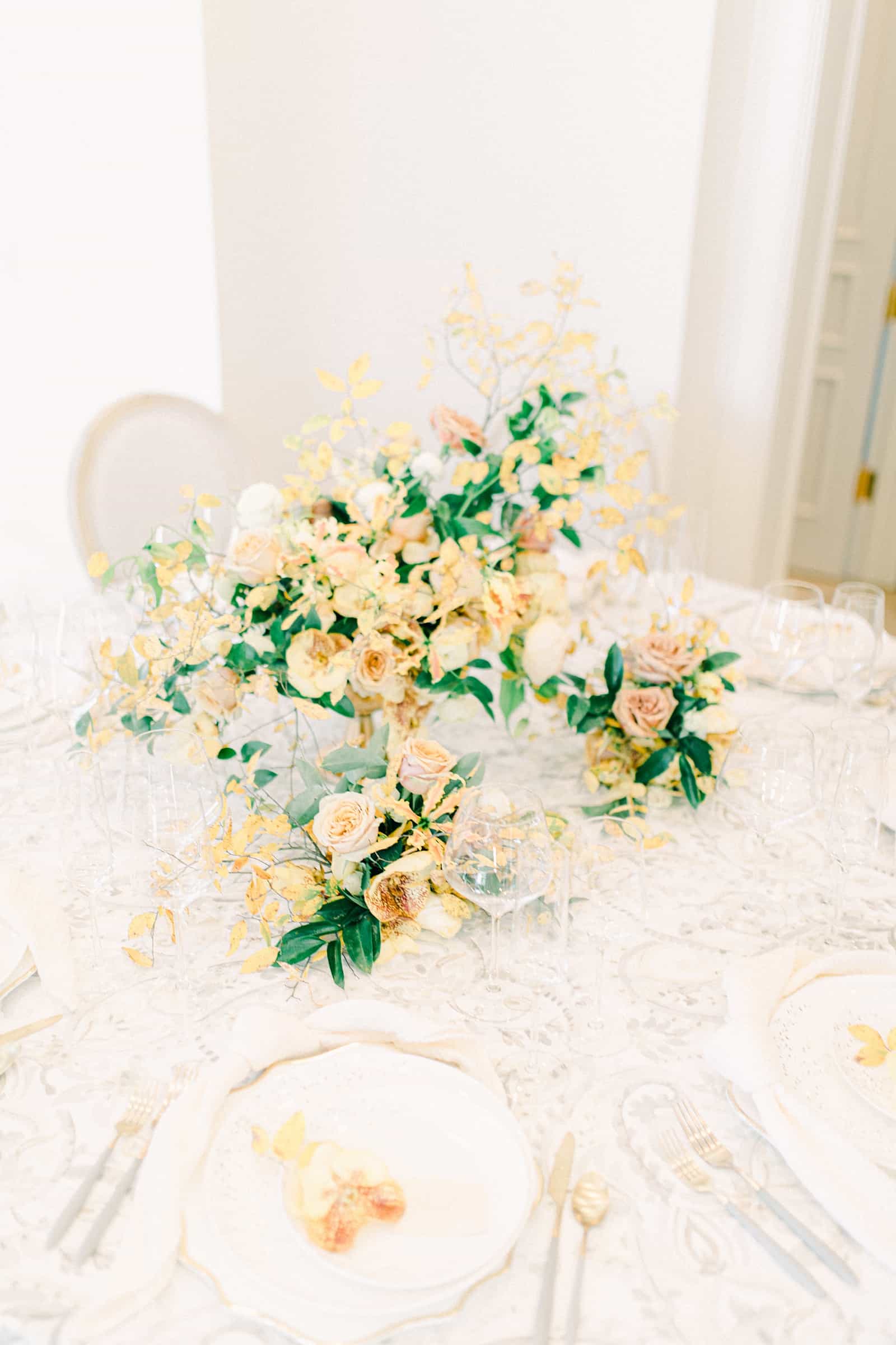 Yellow and white wedding fall centerpiece with orange orchids, secret garden wedding