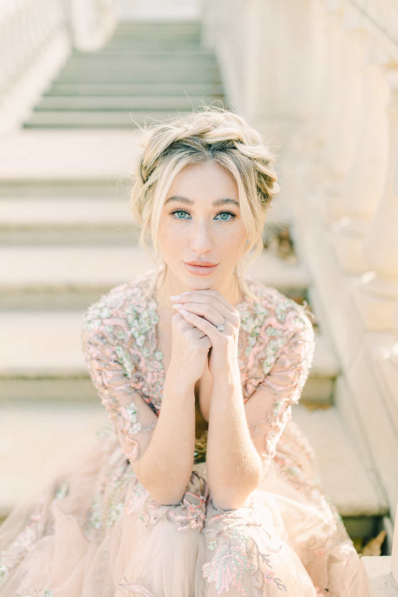 European bride with crown of braids wearing flower embellished wedding dress