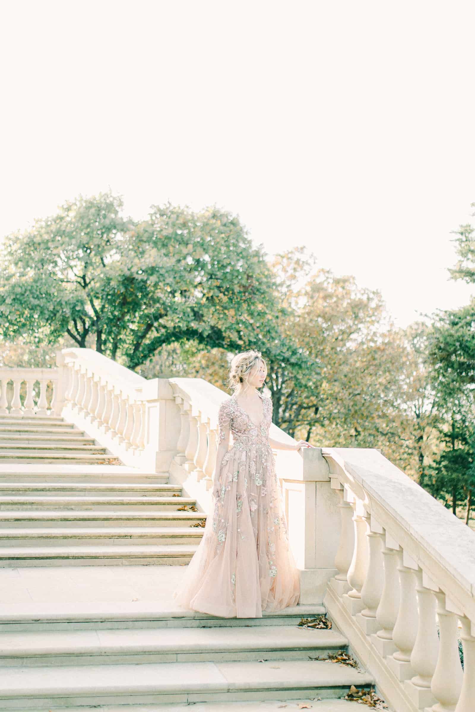 European bride on marble staircase wearing couture wedding dress, YSA Makino designer wedding dress
