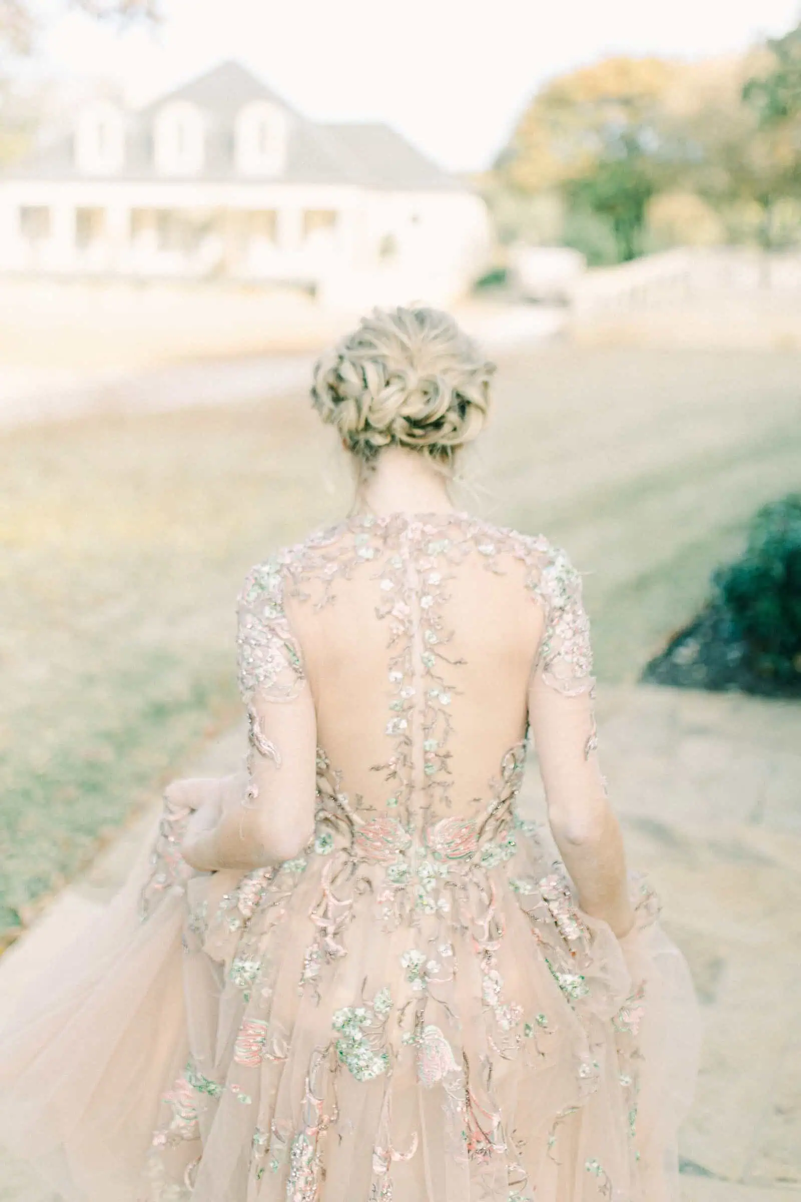 Back button details of couture wedding dress, blush pink gown with floral embroidery and embellishments, unique wedding dress